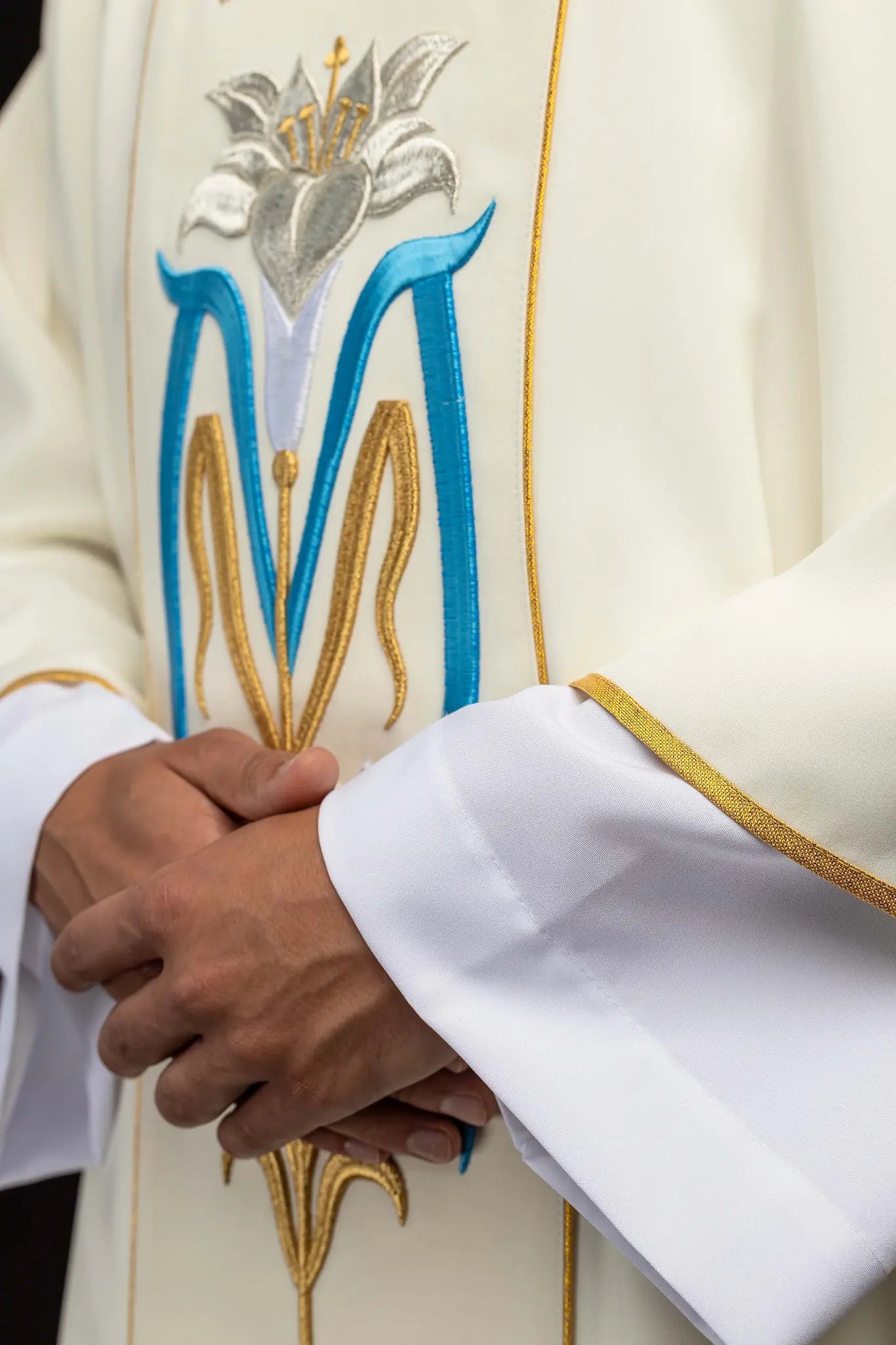Ecru dalmatic with Marian embroidery, gold trim, and a matching stole.