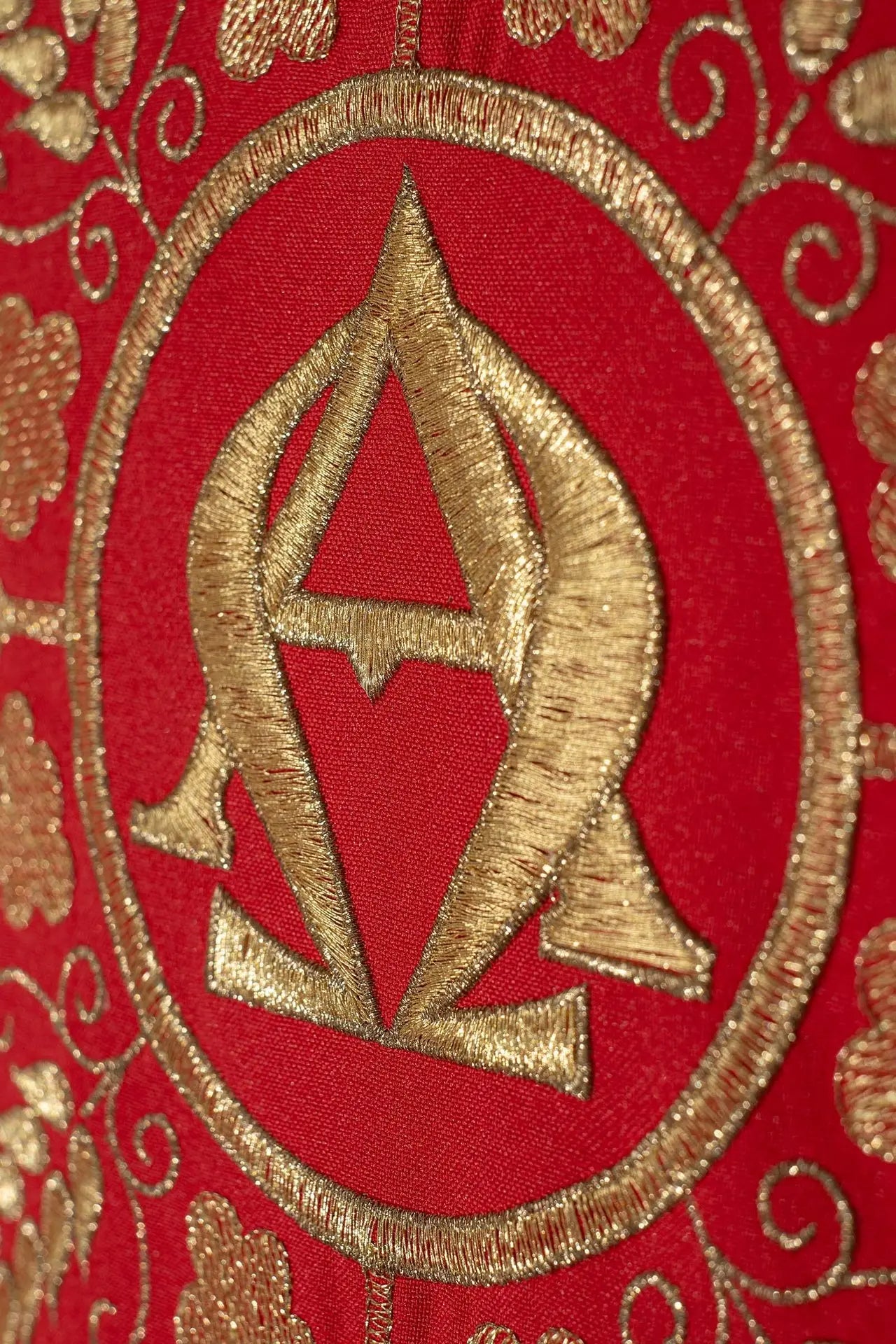 Red chasuble embroidered with the Alpha and Omega symbols and ears of whea