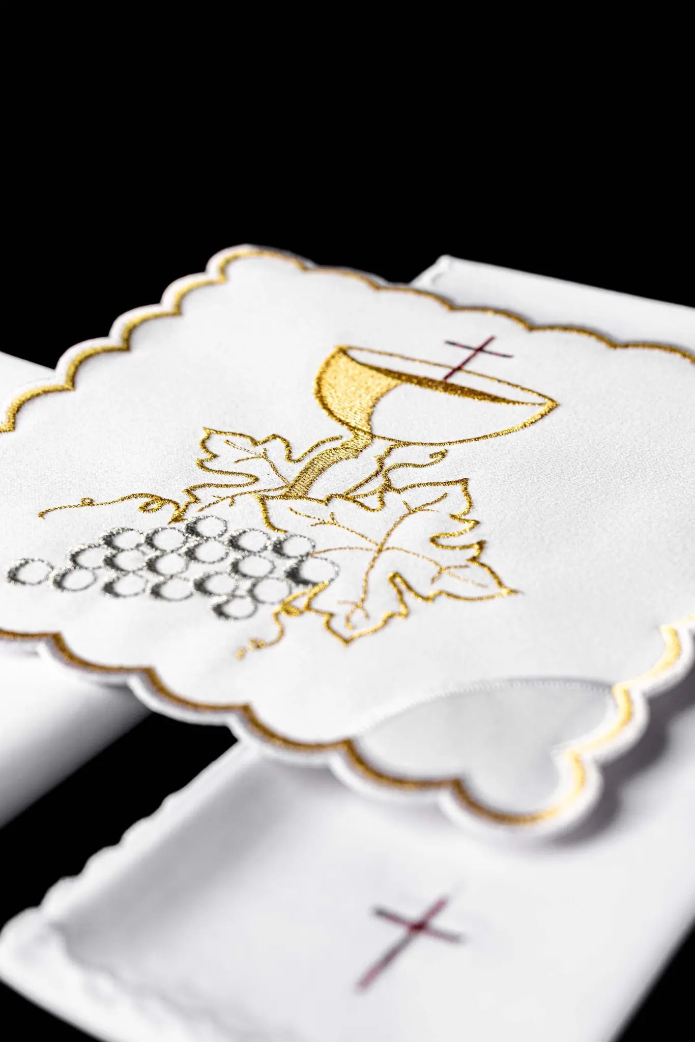 White chalice linen set with IHS monogram embroidery on the pall and cross embroidery on the purificator and lavabo towel.