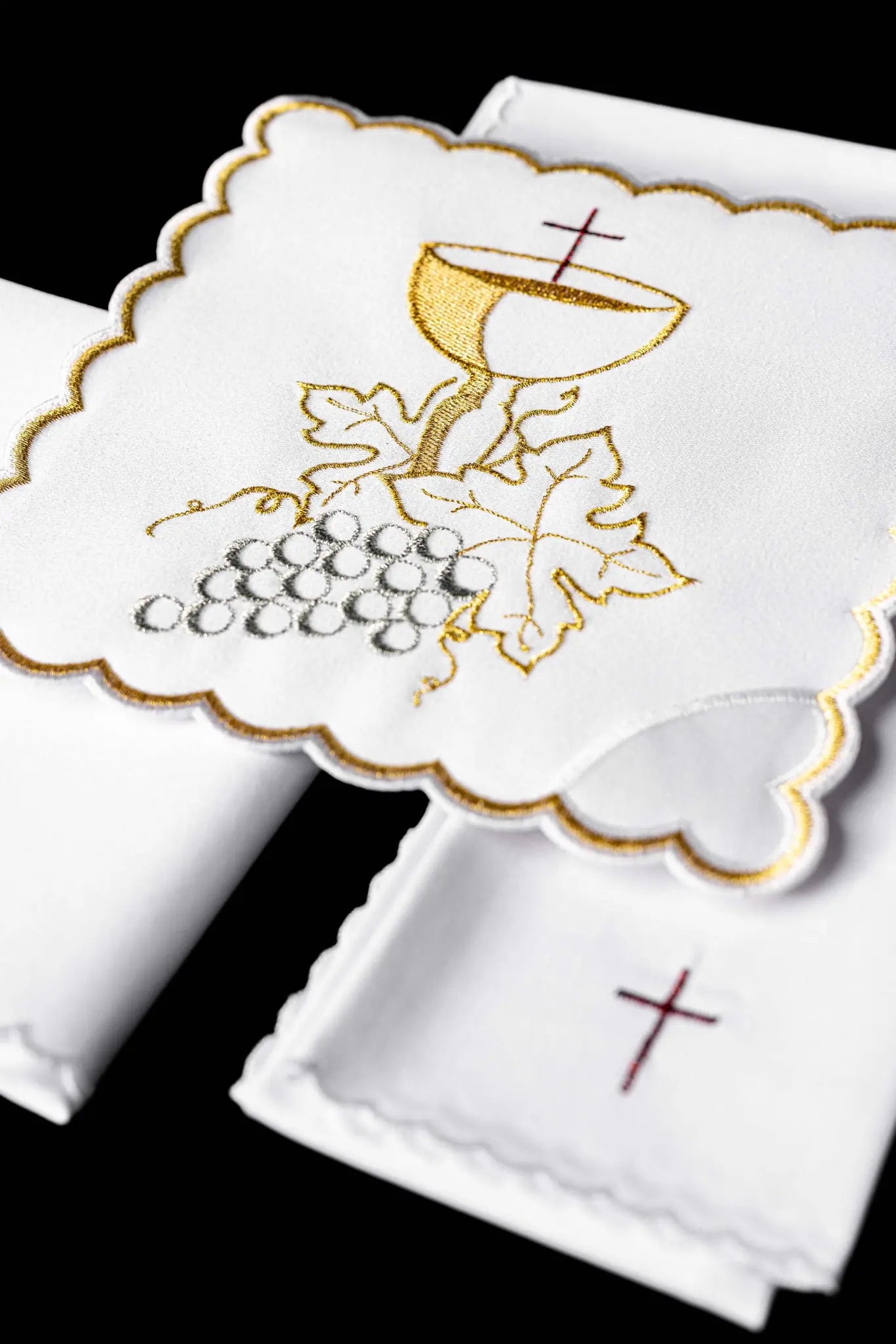 White chalice linen set with IHS monogram embroidery on the pall and cross embroidery on the purificator and lavabo towel.