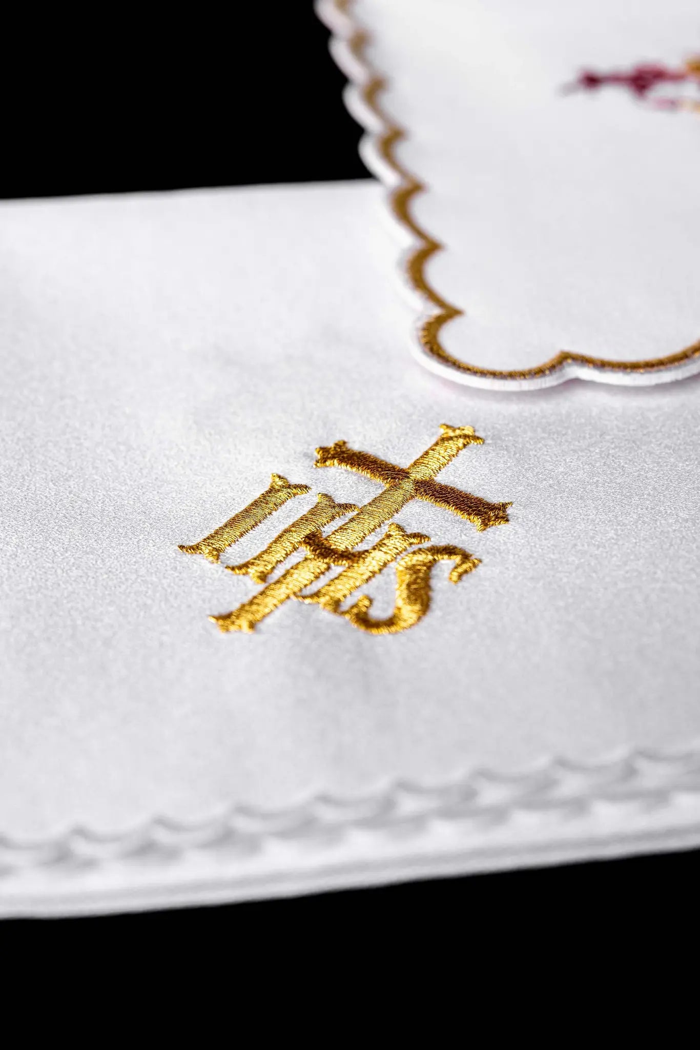 White chalice linen set with IHS embroidery, including pall, corporal, purificator, and lavabo towel.