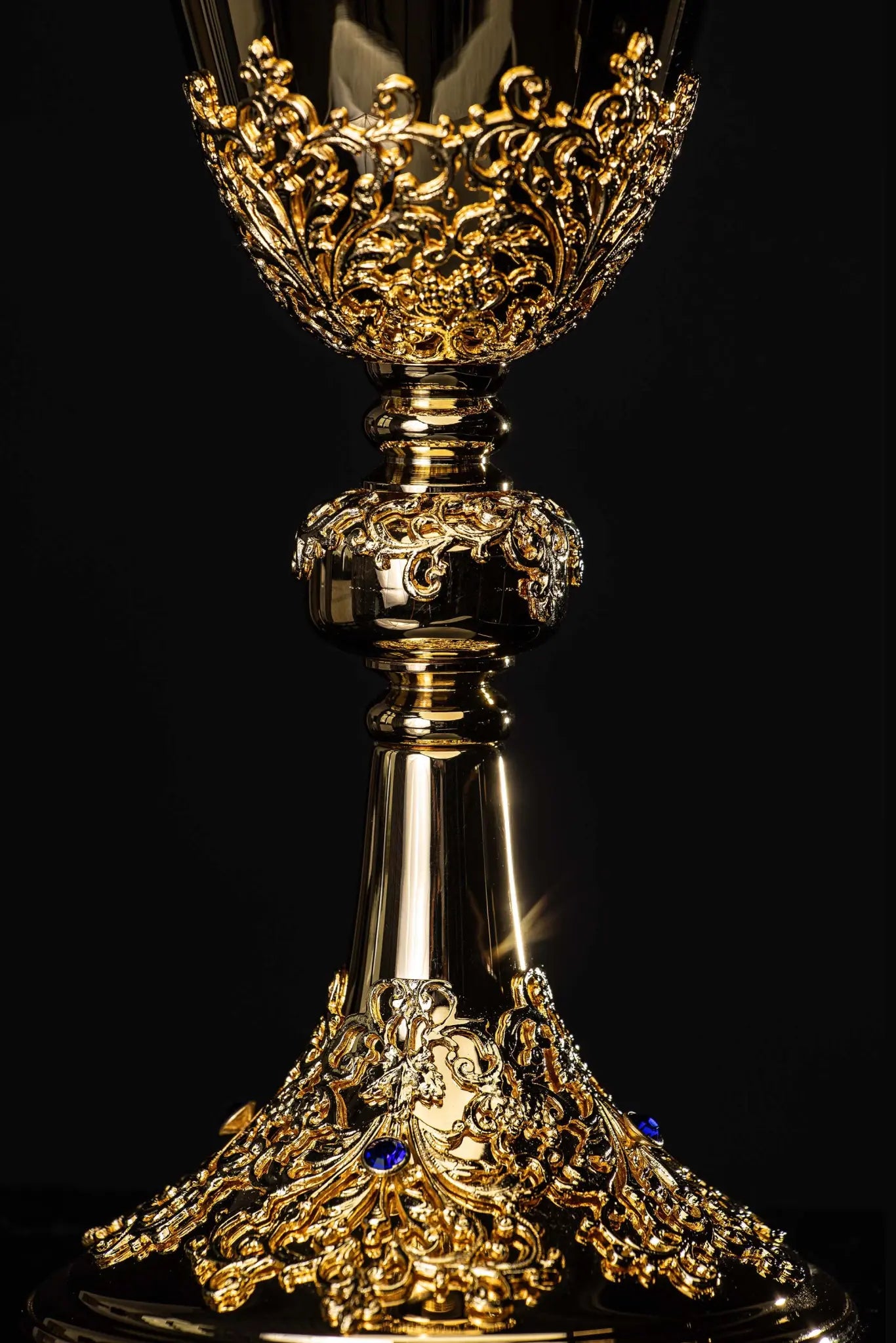 Handmade gold-plated chalice with floral ornamentation on the cup, knop, and base, adorned with blue imitation sapphires.