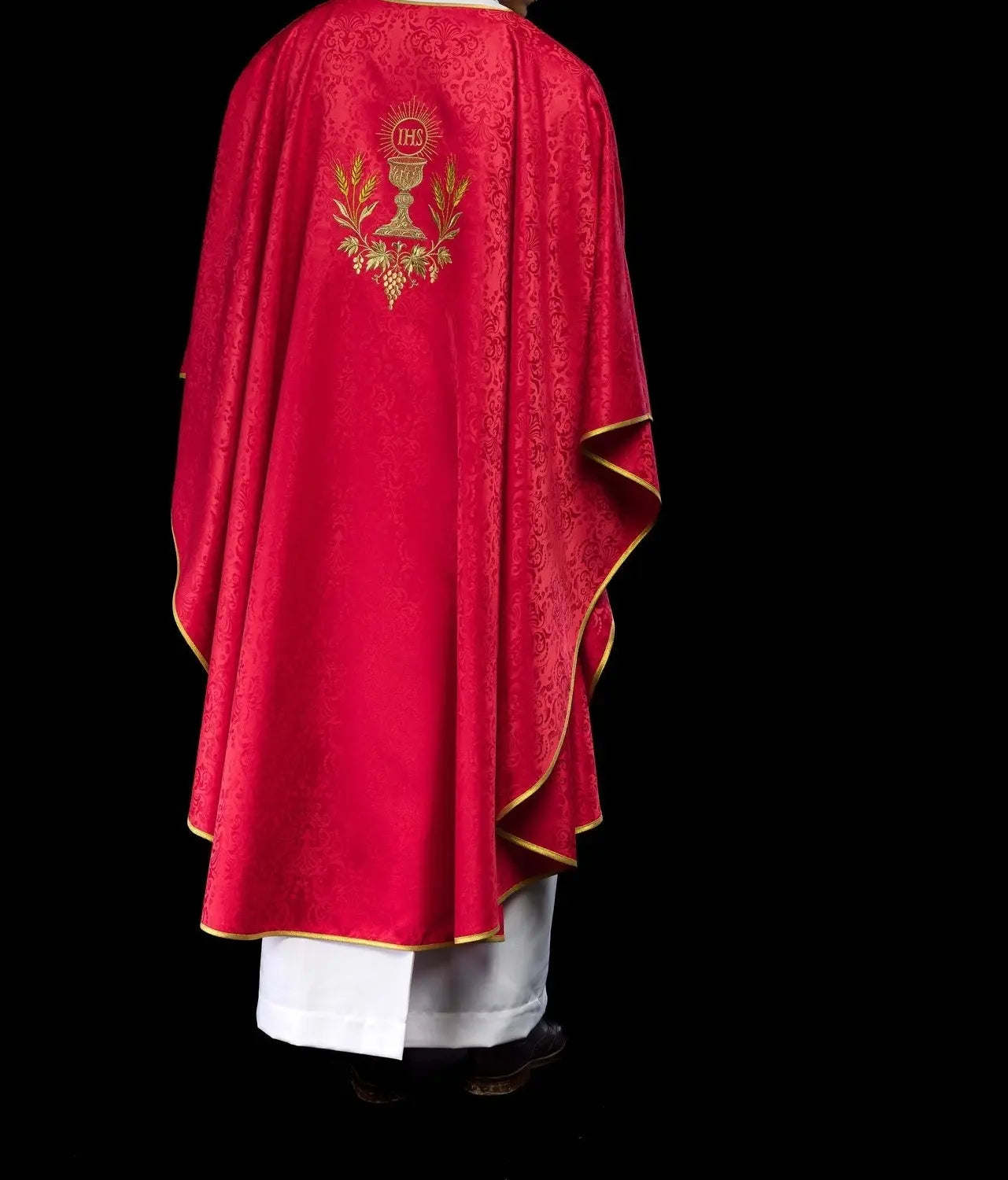Red liturgical chasuble with an embroidered chalice and host on jacquard fabric