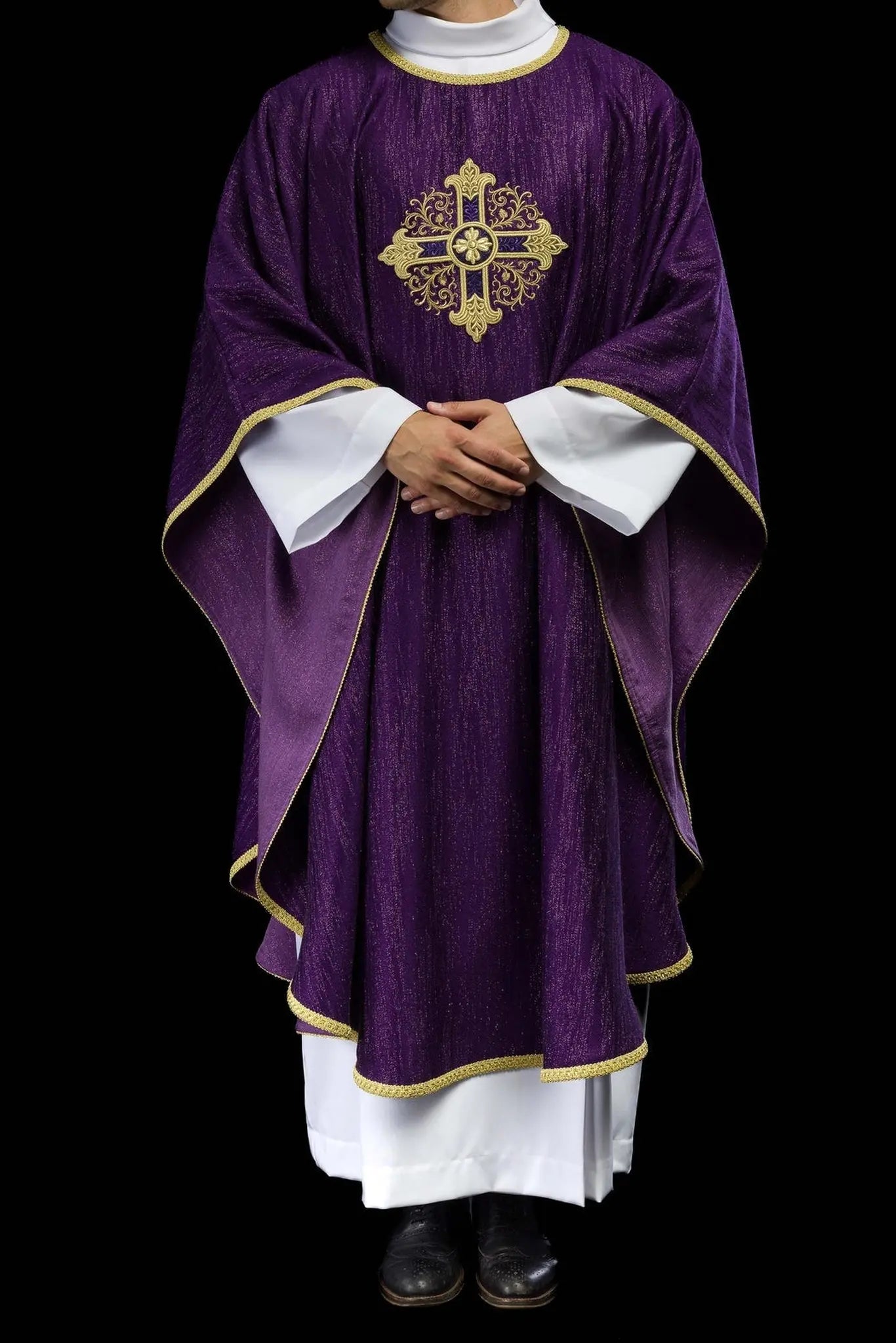 Ornat liturgiczny w kolorze fioletowym z haftowanym motywem krzyża na ozdobnej tkaninie