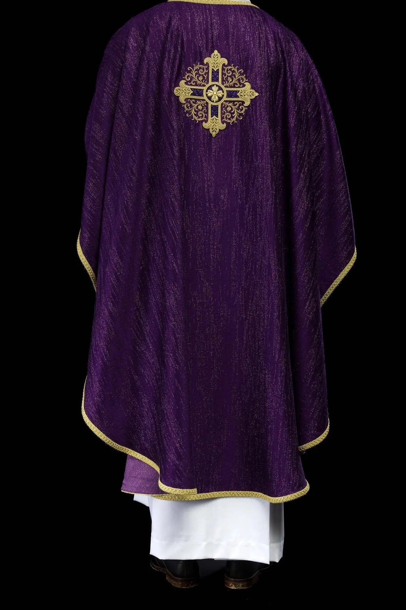 Purple liturgical chasuble with an embroidered cross motif on decorative fabric