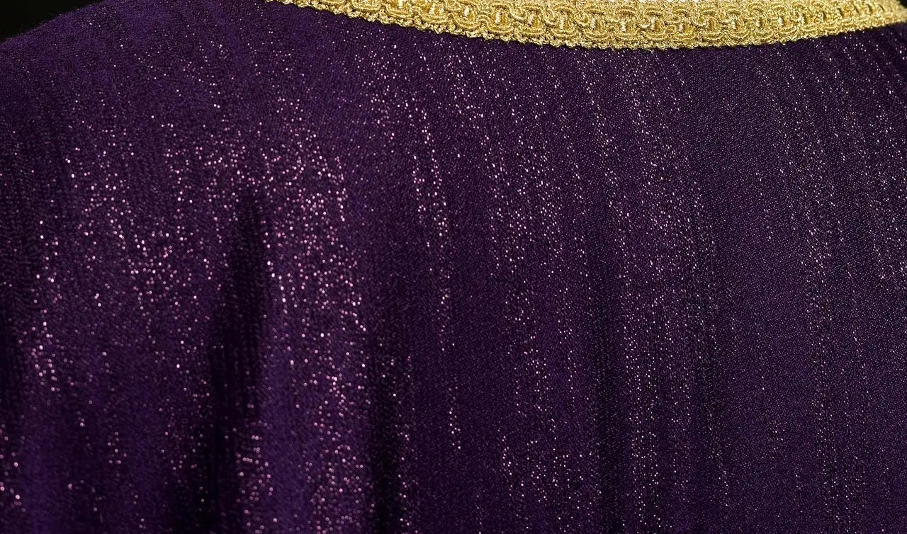 Purple liturgical chasuble with an embroidered cross motif on decorative fabric