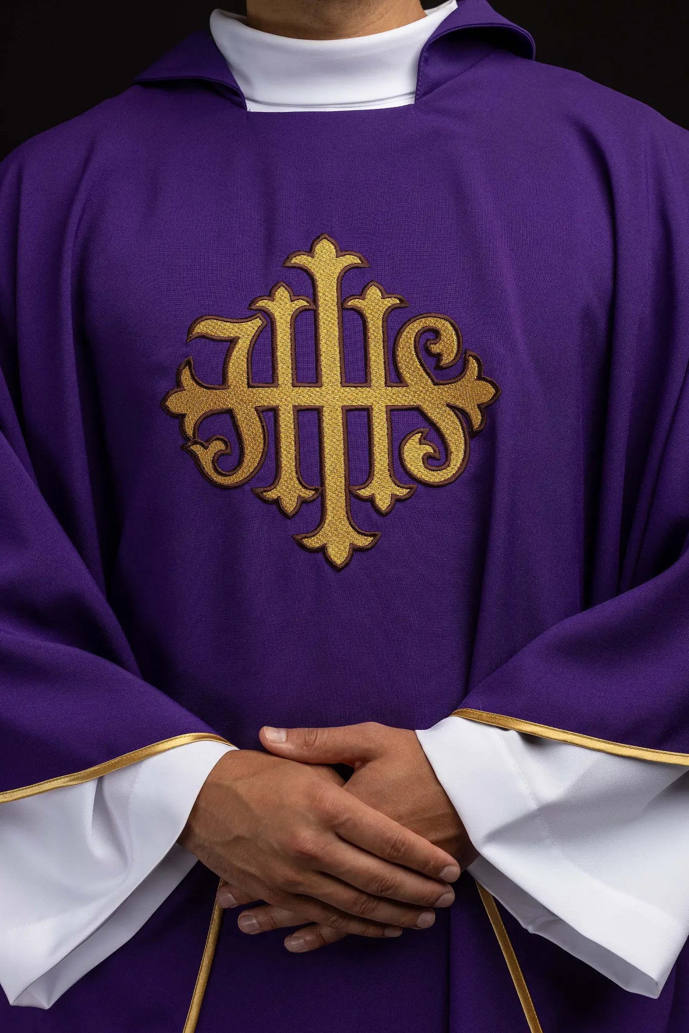 Purple chasuble with embroidered IHS symbol and gold trim, featuring a V-neckline and a matching stole.