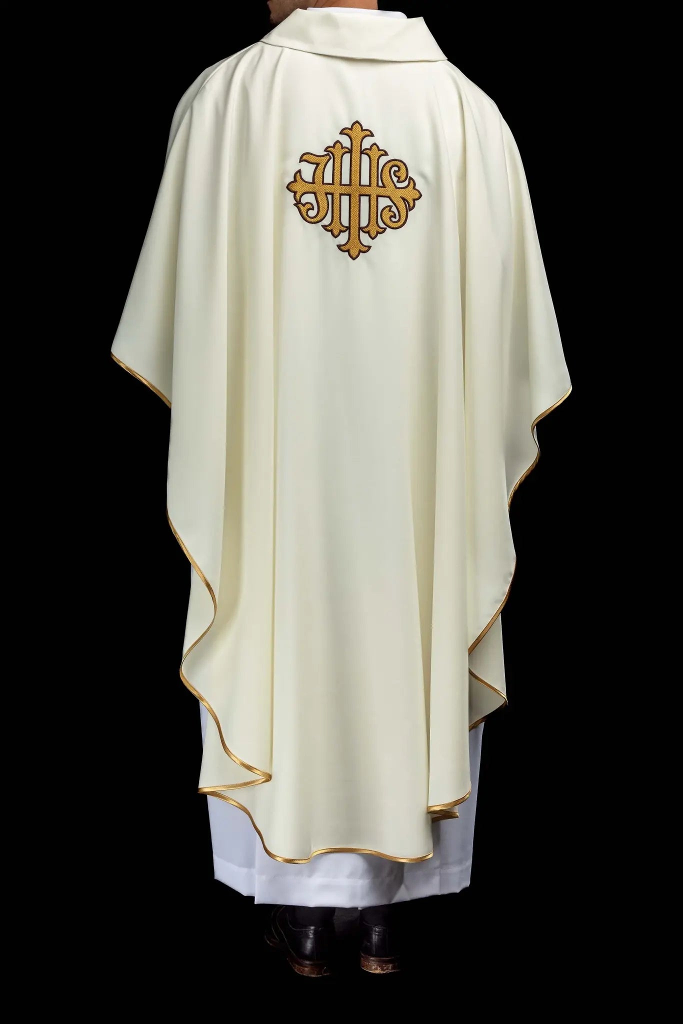Ecru chasuble with gold IHS embroidery and gold trim, featuring a V-neck collar.