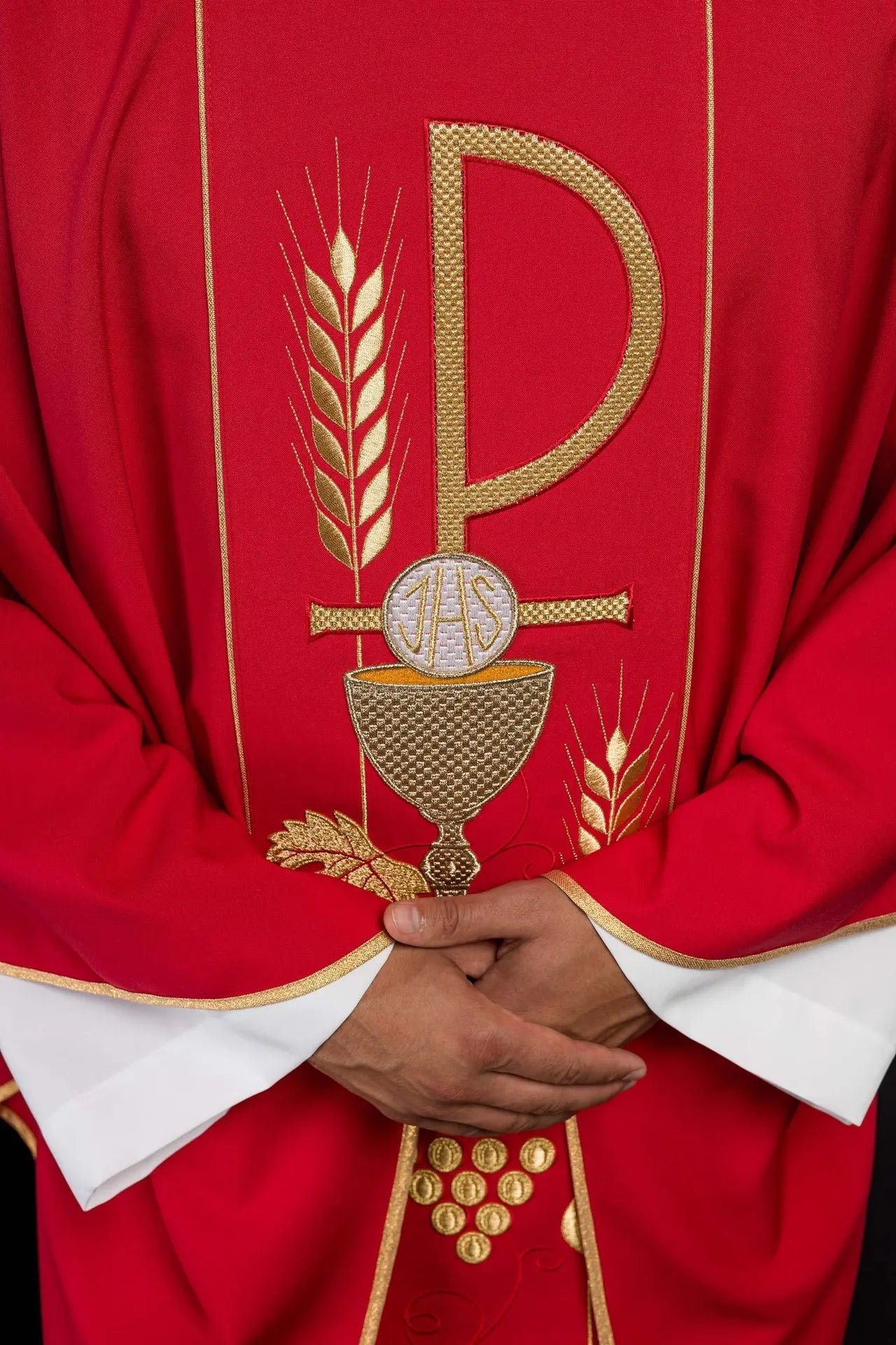 Red chasuble embroidered with IHS chalice design