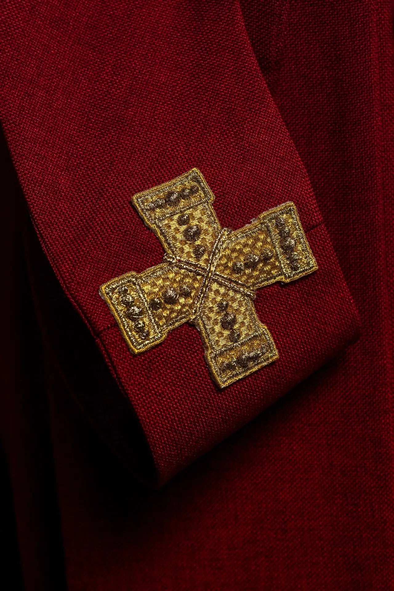 Red chasuble with an embroidered band of crosses