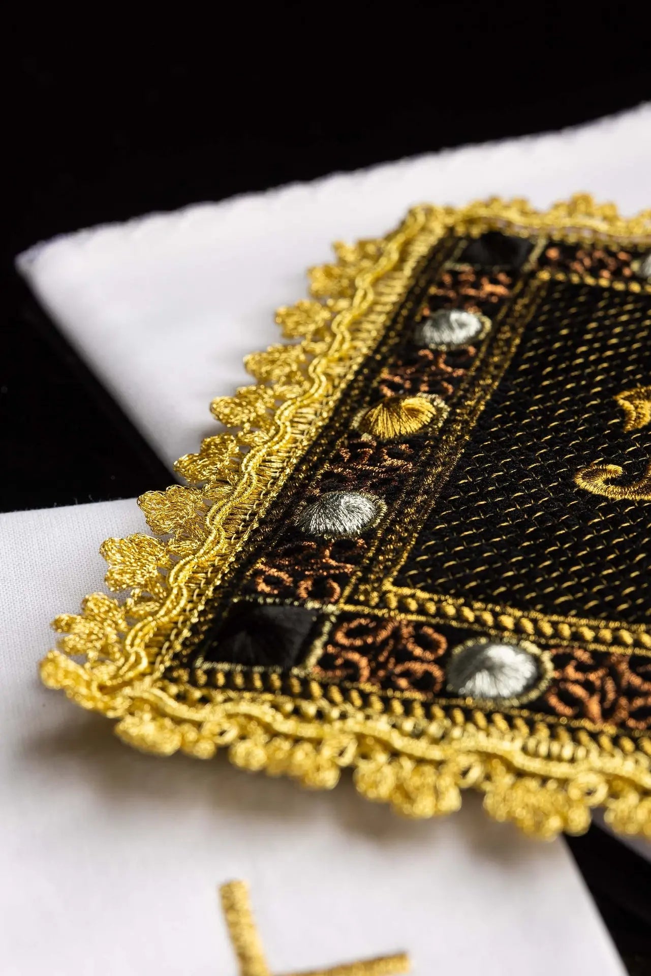 A black velvet chalice linens set with an embroidered IHS symbol