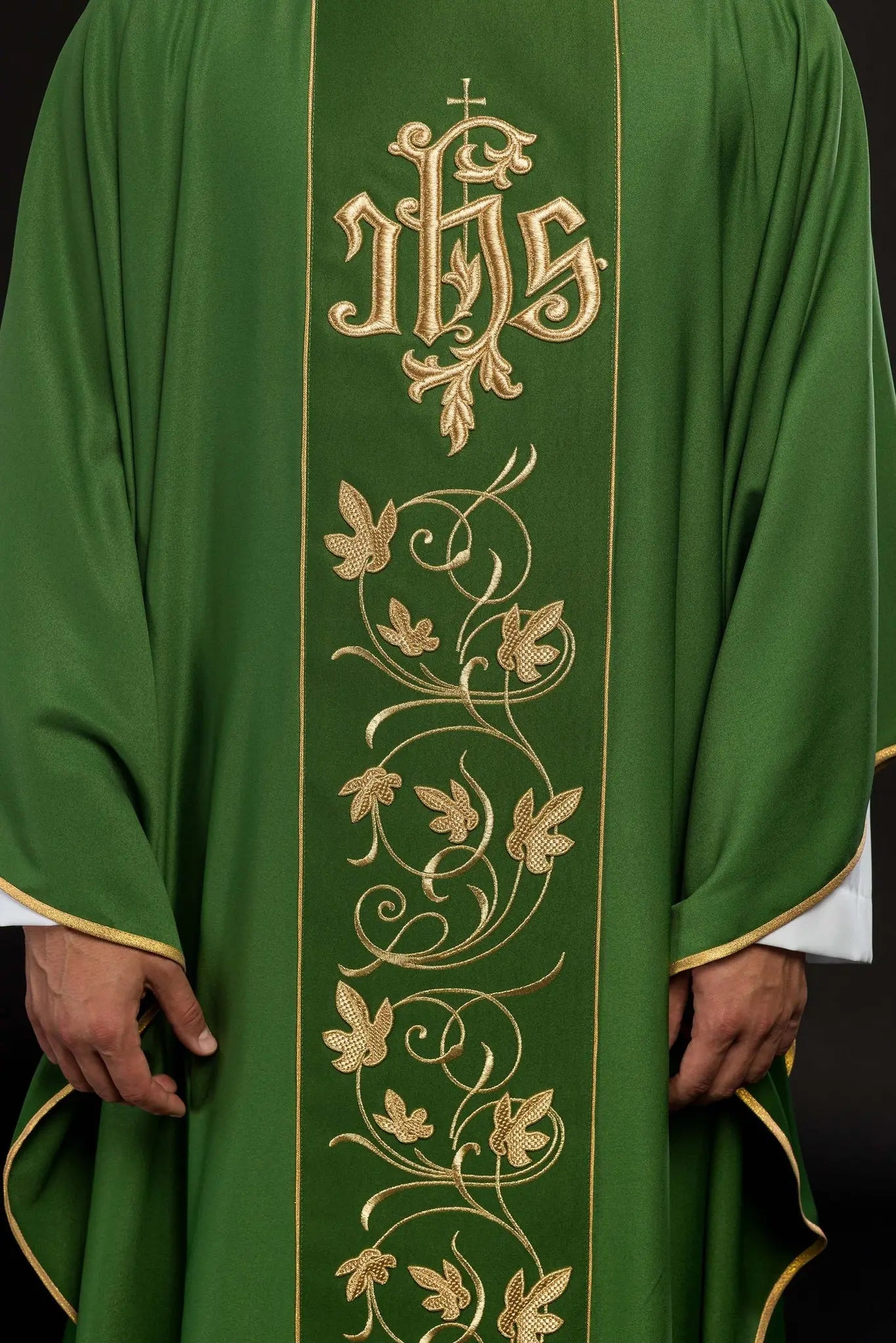 Green liturgical chasuble with richly decorated belt with floral motif and IHS
