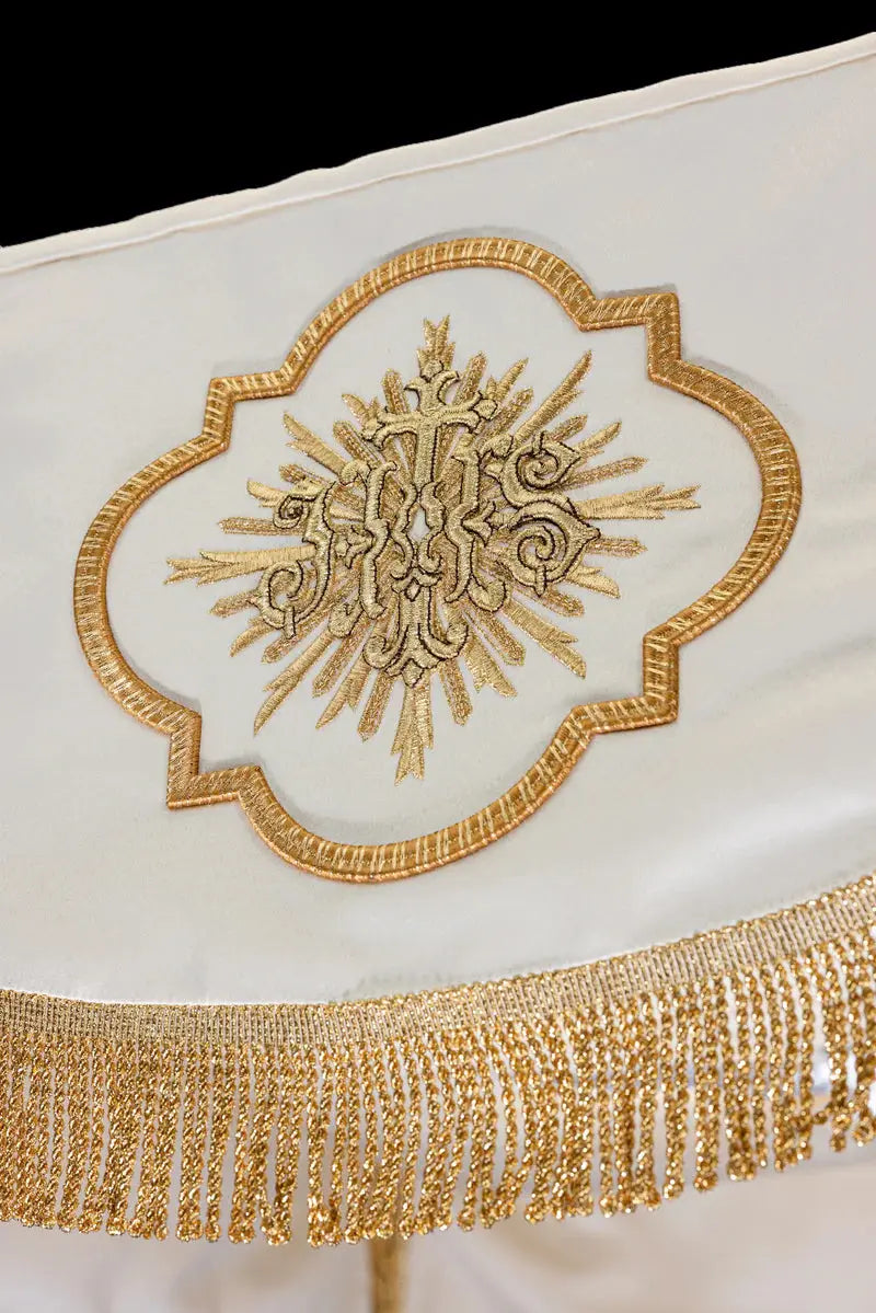 White baldachin with embroidered Corpus Christi, close-up view