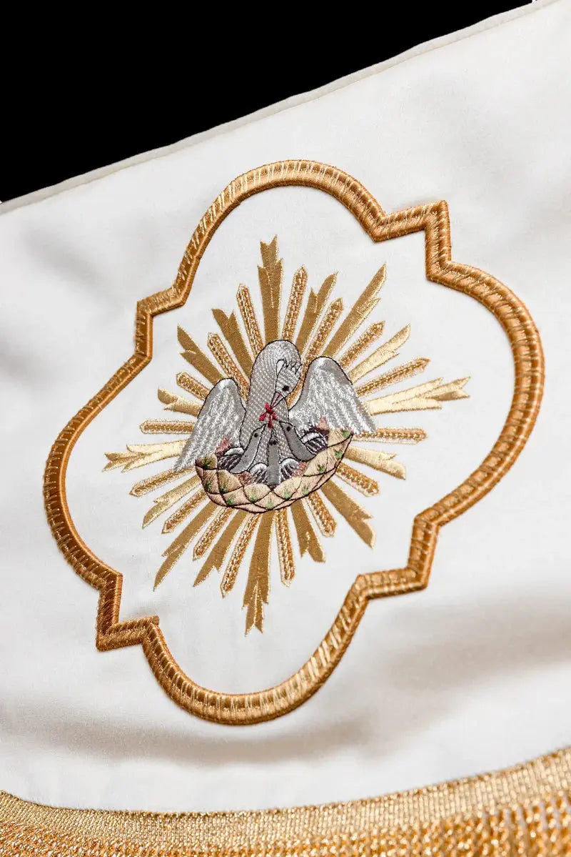 White baldachin with embroidered pelican, close-up view