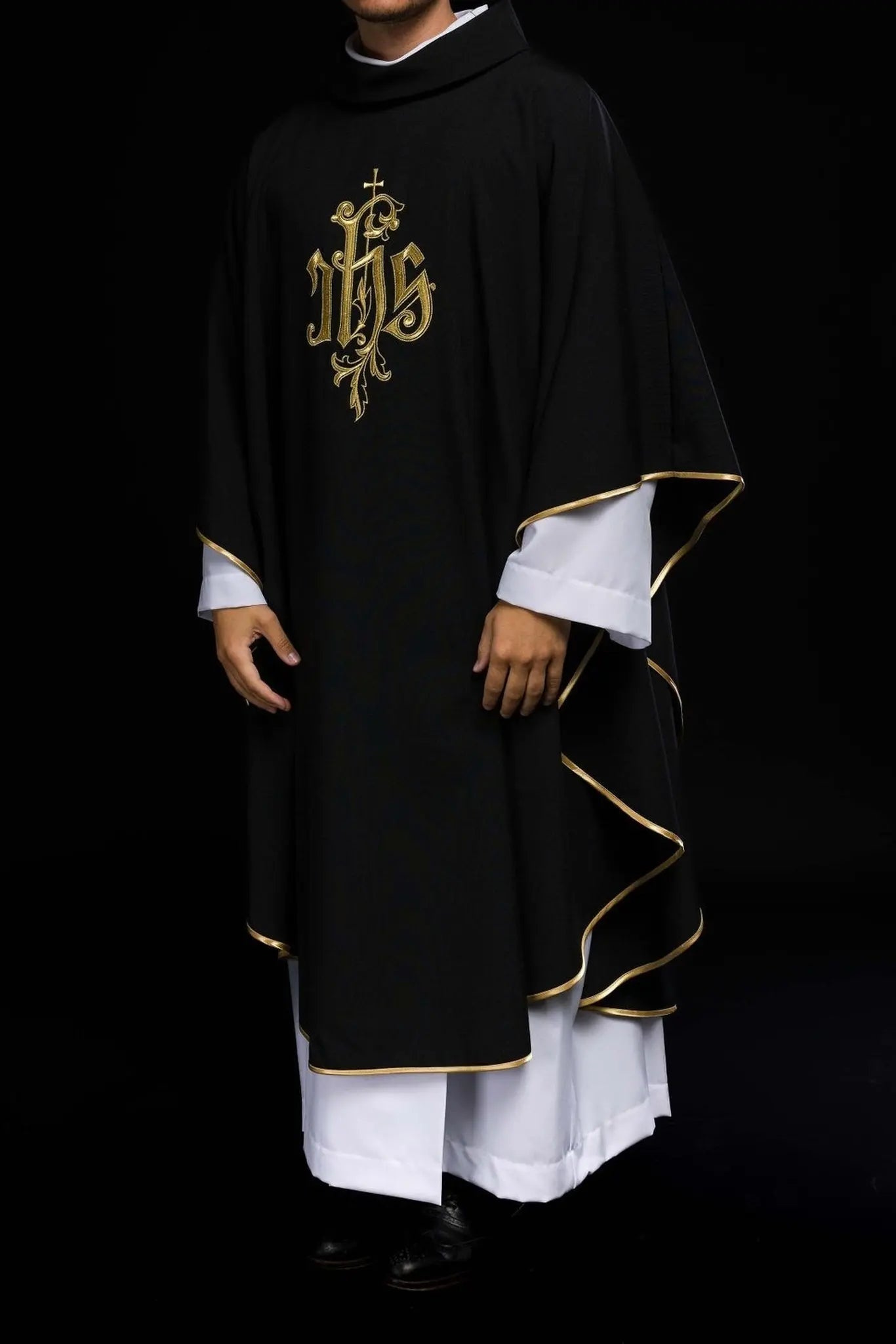 Black chasuble embroidered with IHS