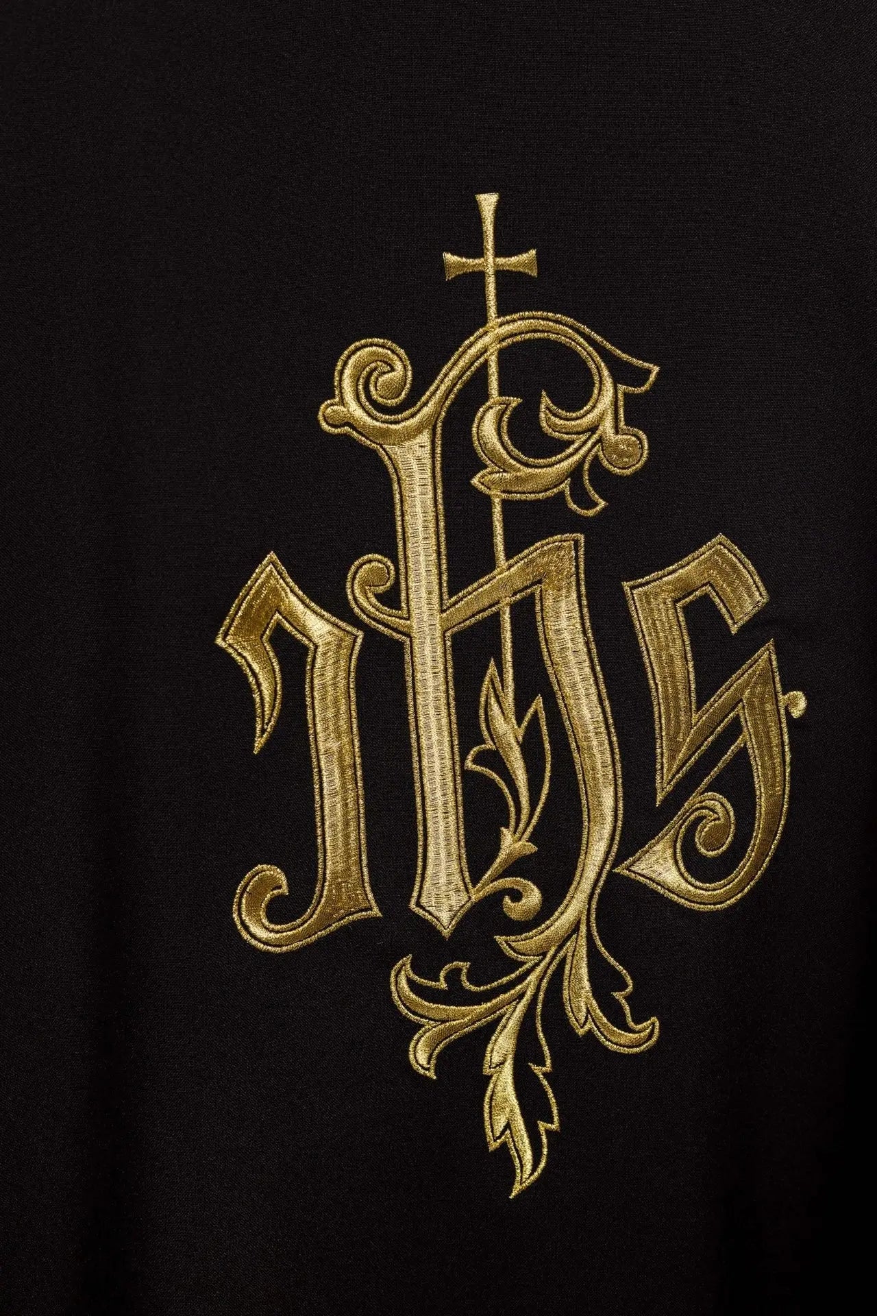 Black chasuble embroidered with IHS