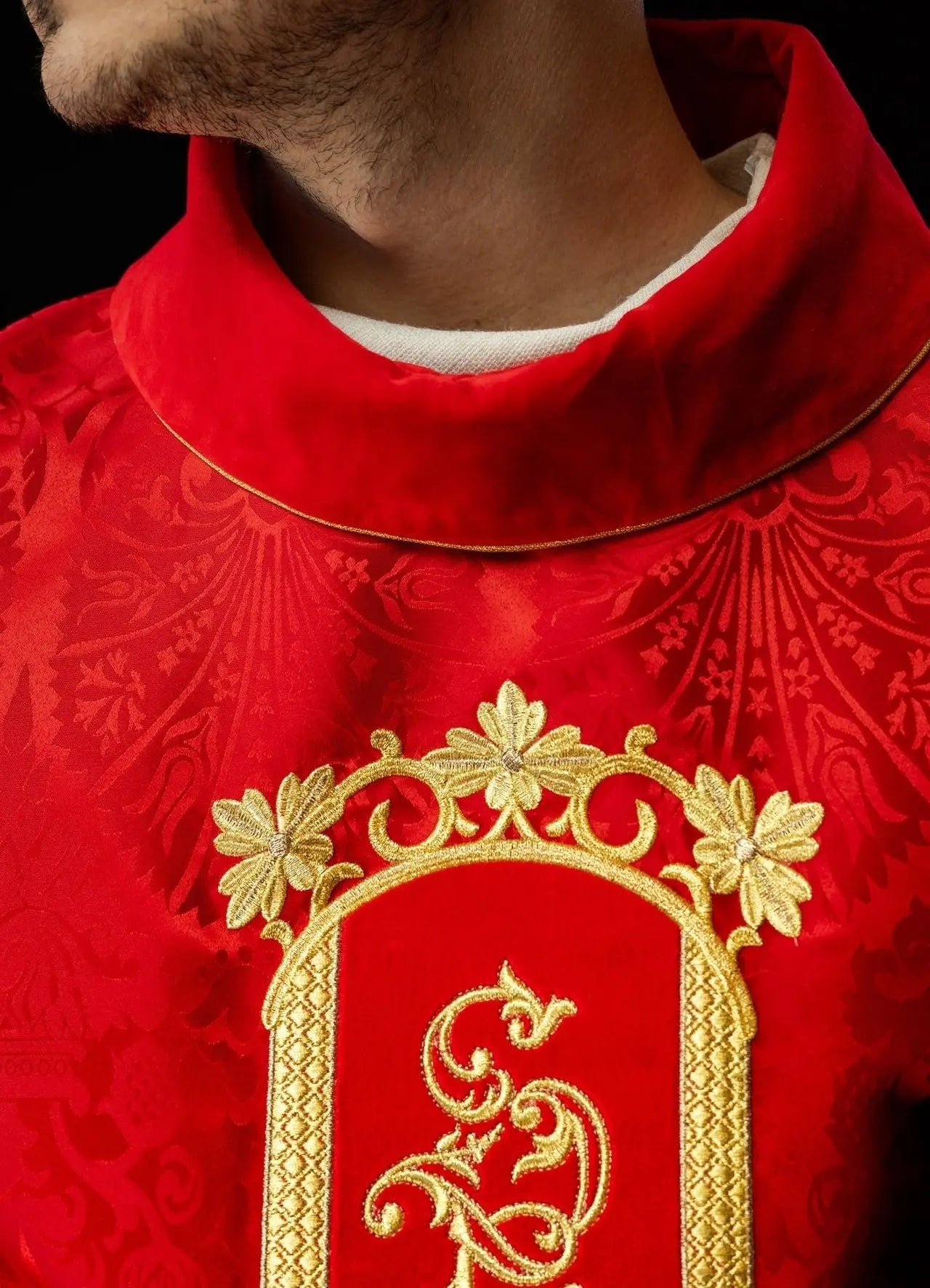 Red chasuble embroidered with the pattern of Jesus Christ
