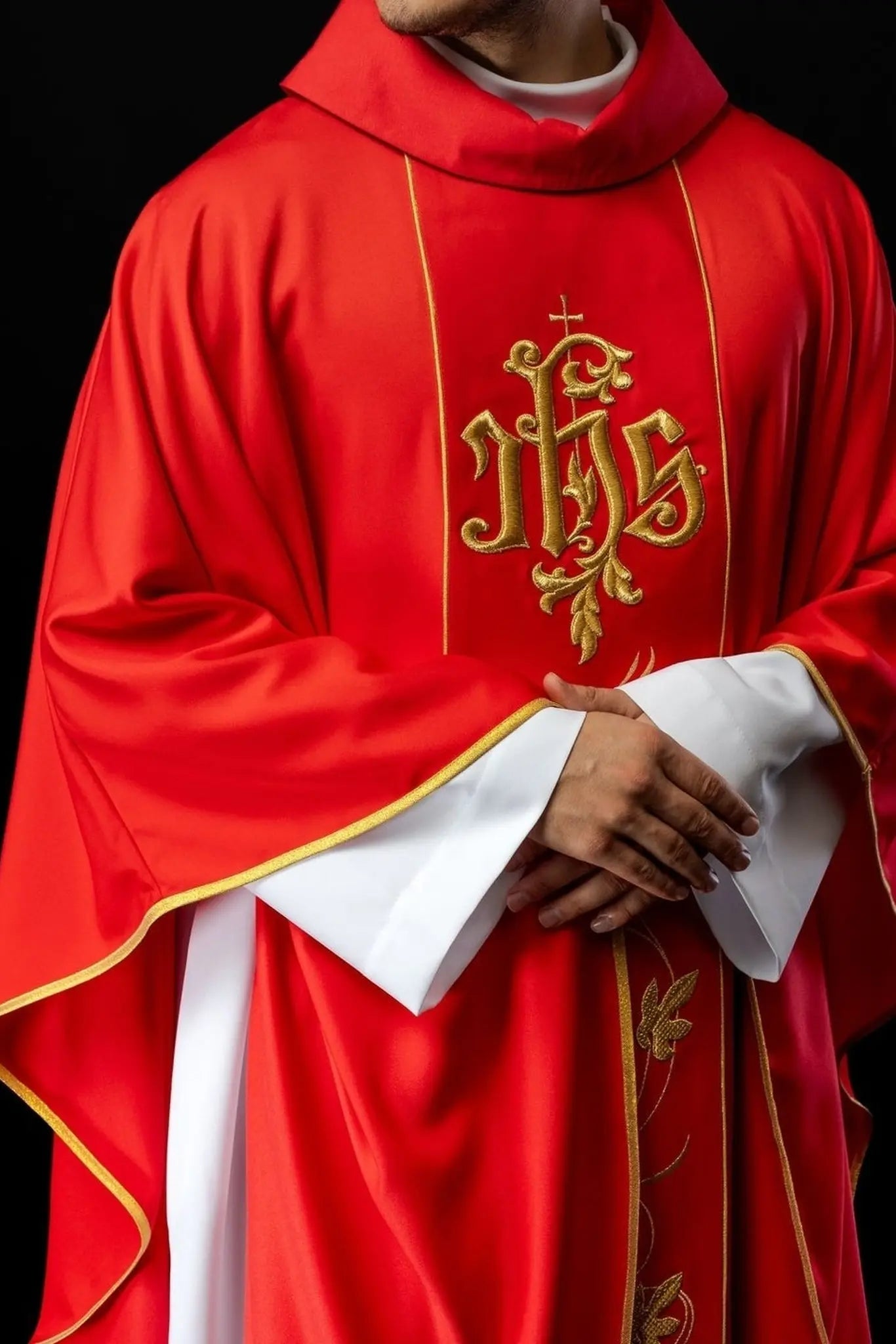 Czerwony ornat liturgiczny z bogato zdobionym pasem z motywem kwiatowym i IHS
