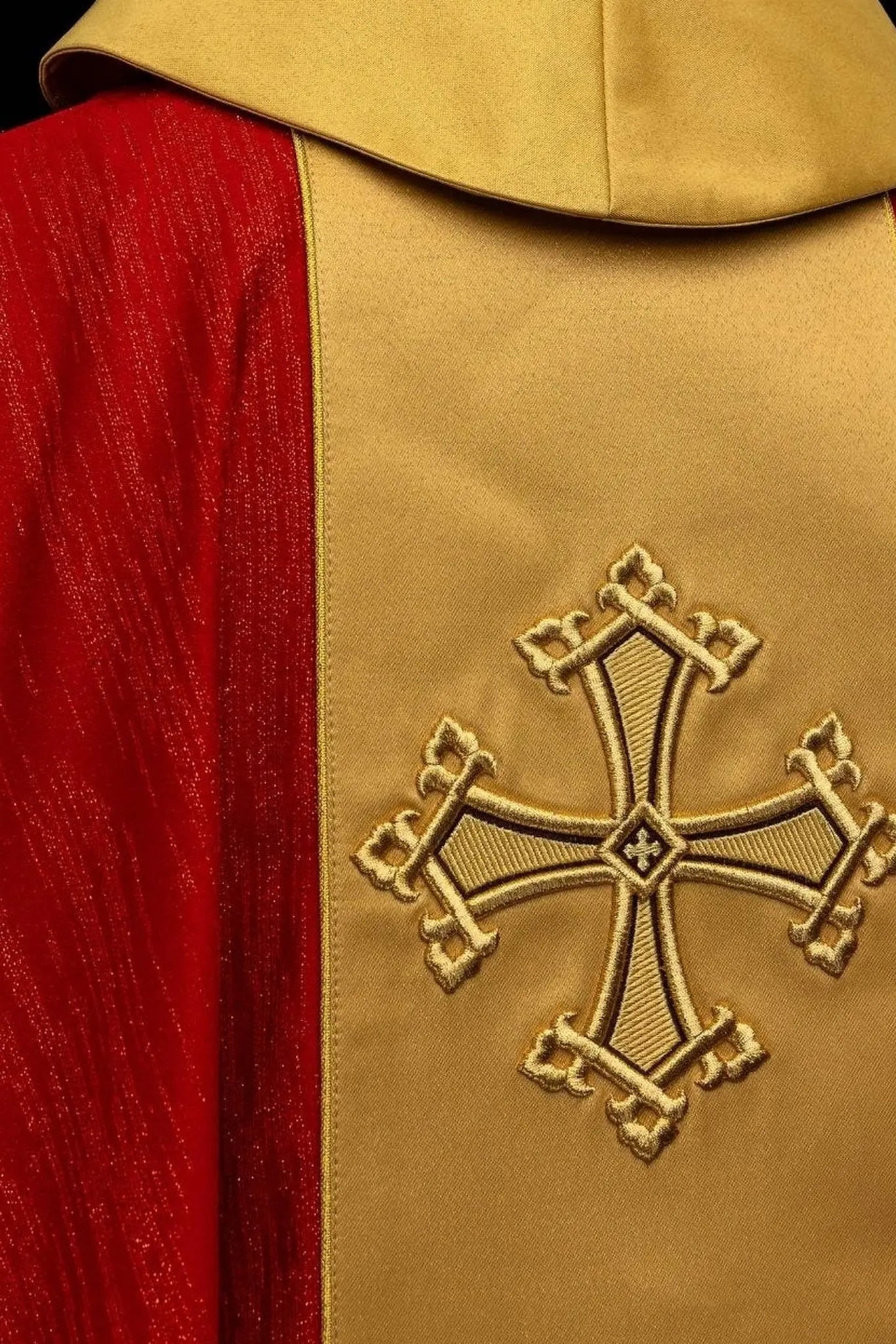 Red chasuble with embroidered cross motif and decorative gold band