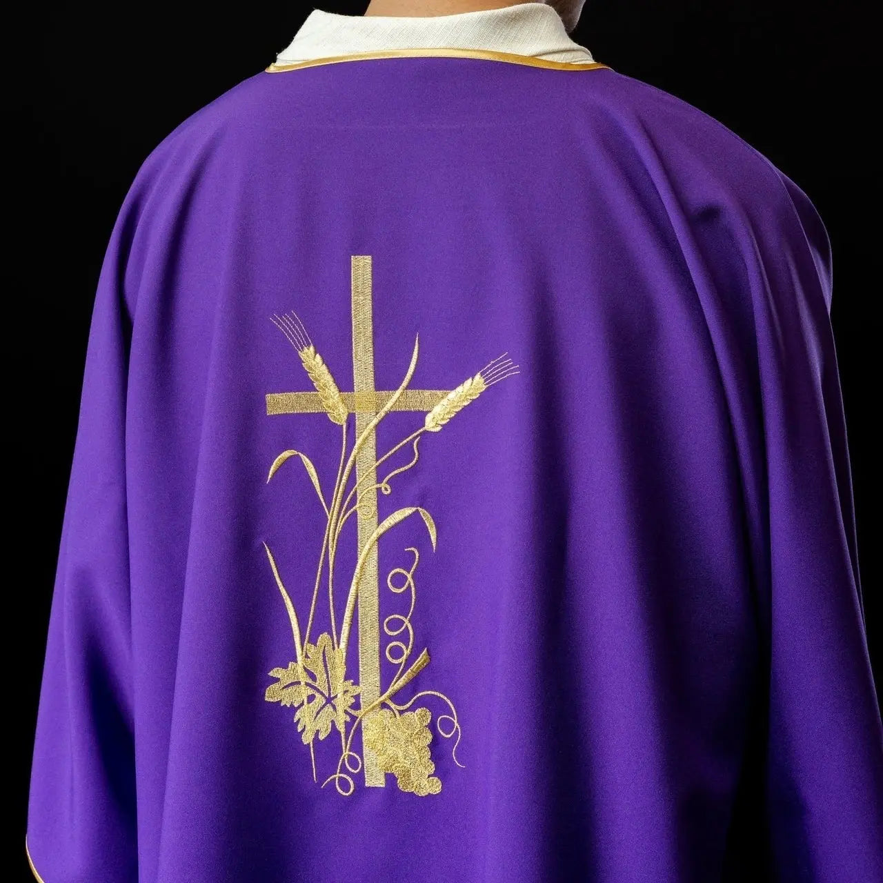 Purple dalmatica with gold Pax cross embroidery