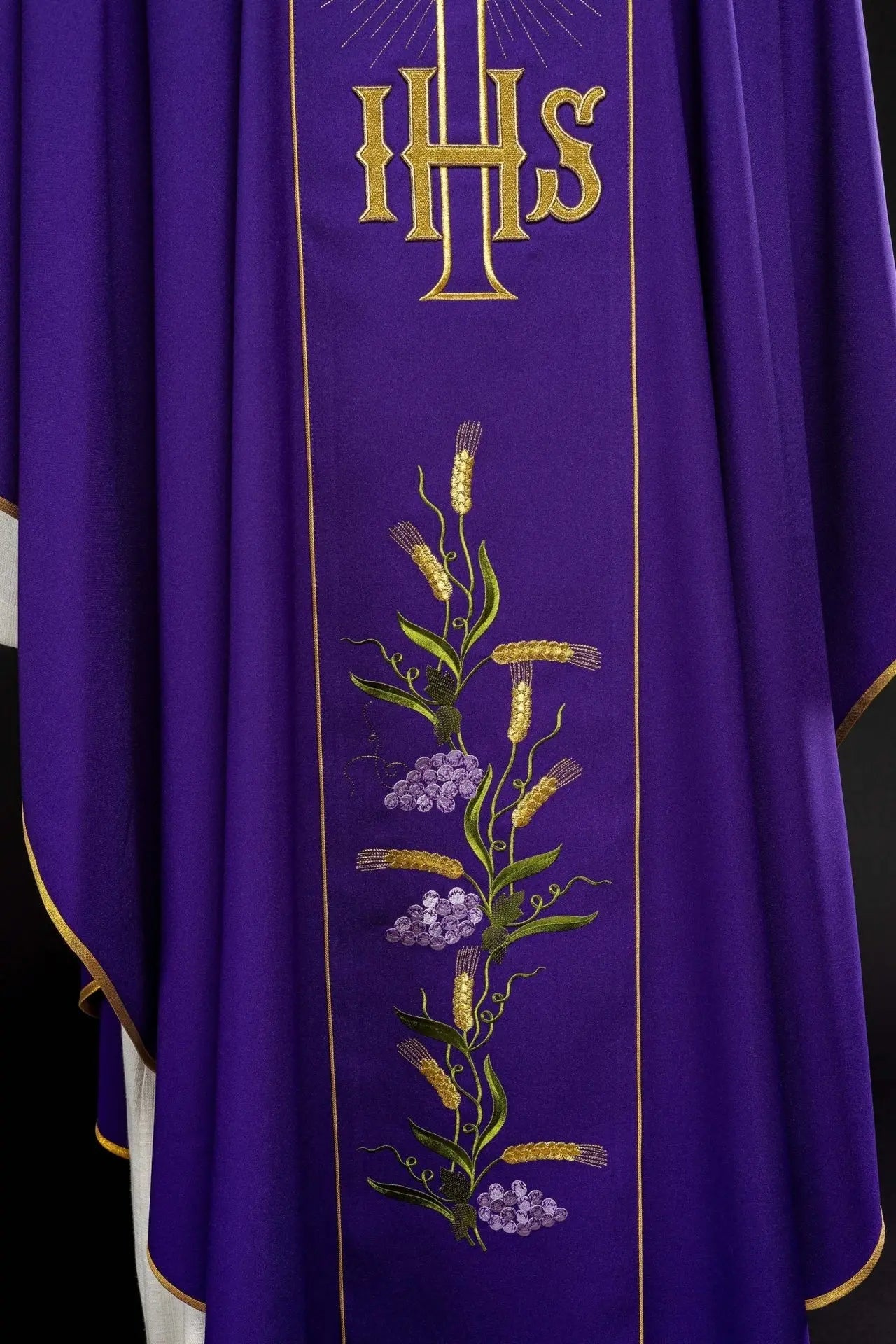 Purple chasuble with decorated gold belt with IHS and ears