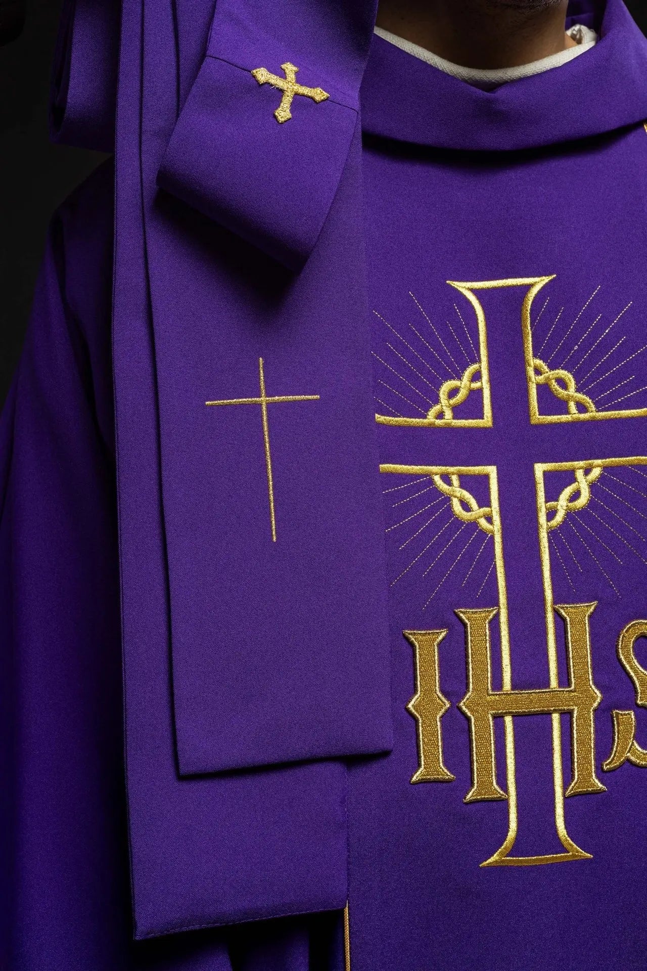 Purple chasuble with decorated gold belt with IHS and ears