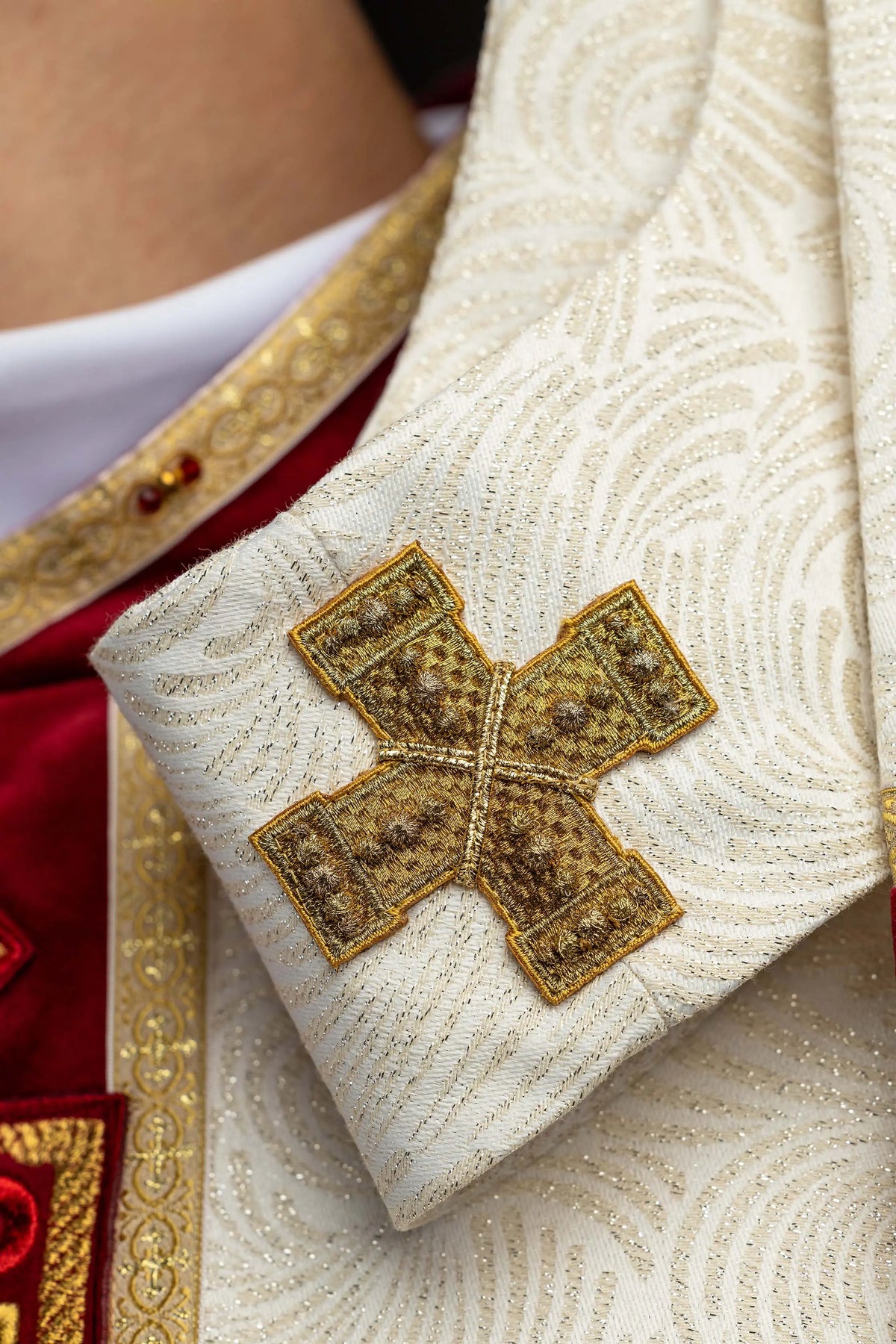 Ecru ornat wielkanocny z haftowanym krzyżem, zbliżenie rękawa z krzyżem