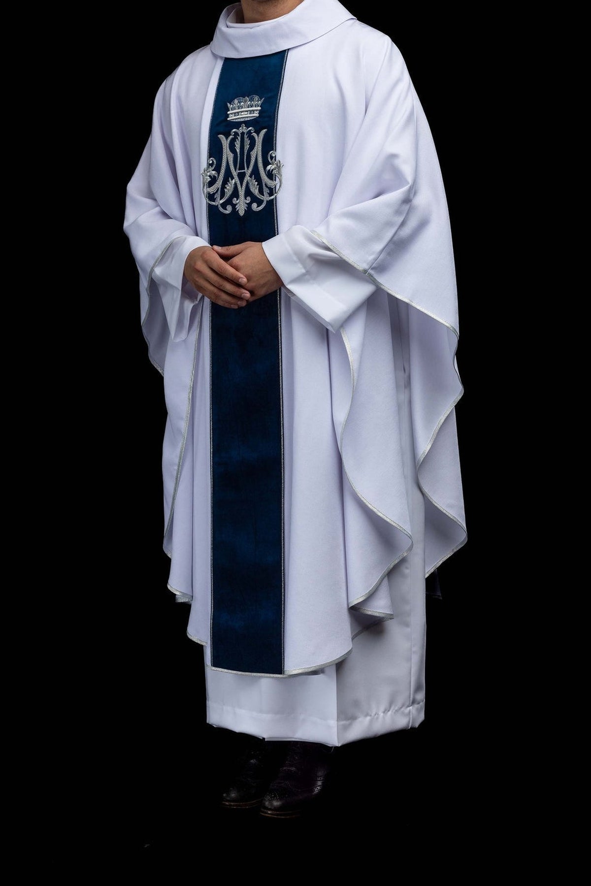 White chasuble with embroidered crowned Marian monogram, angled front view