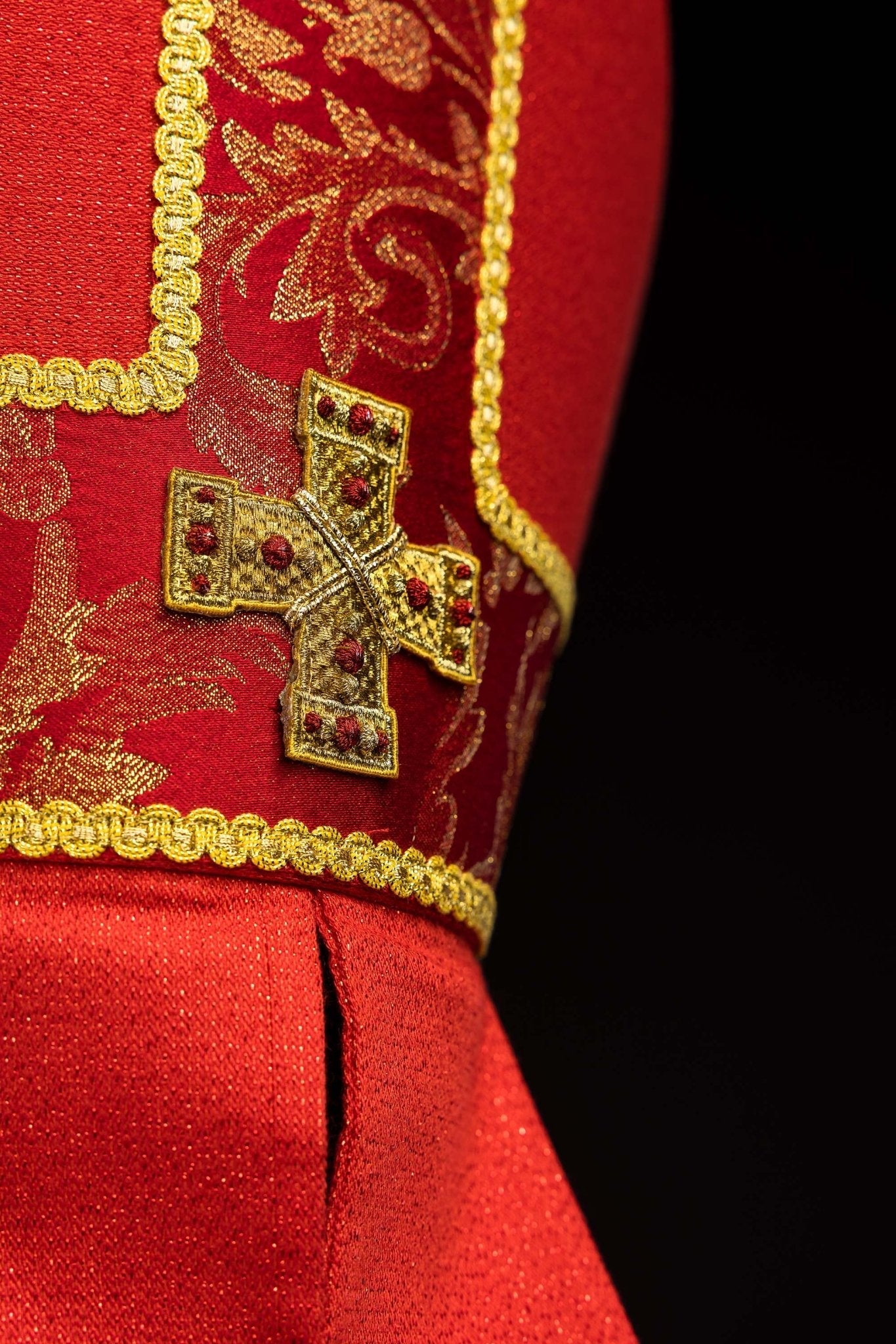 Red embroidered mitre with a cross motif and decorative jacquard fabric