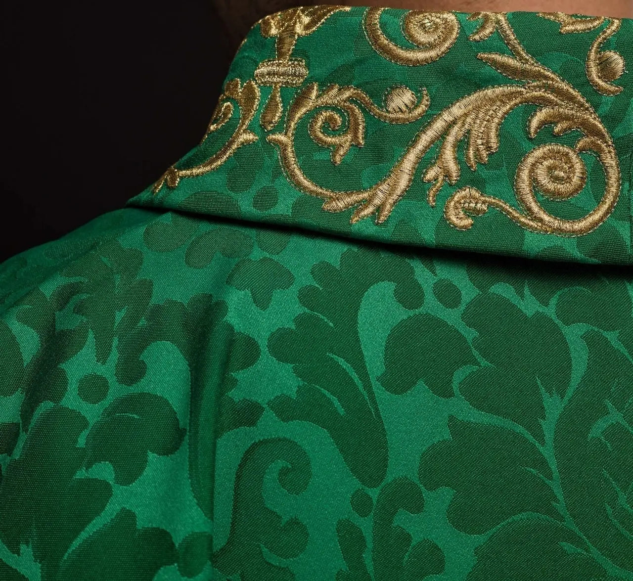 Green chasuble with IHS motif and richly embroidered collar on decorative fabric