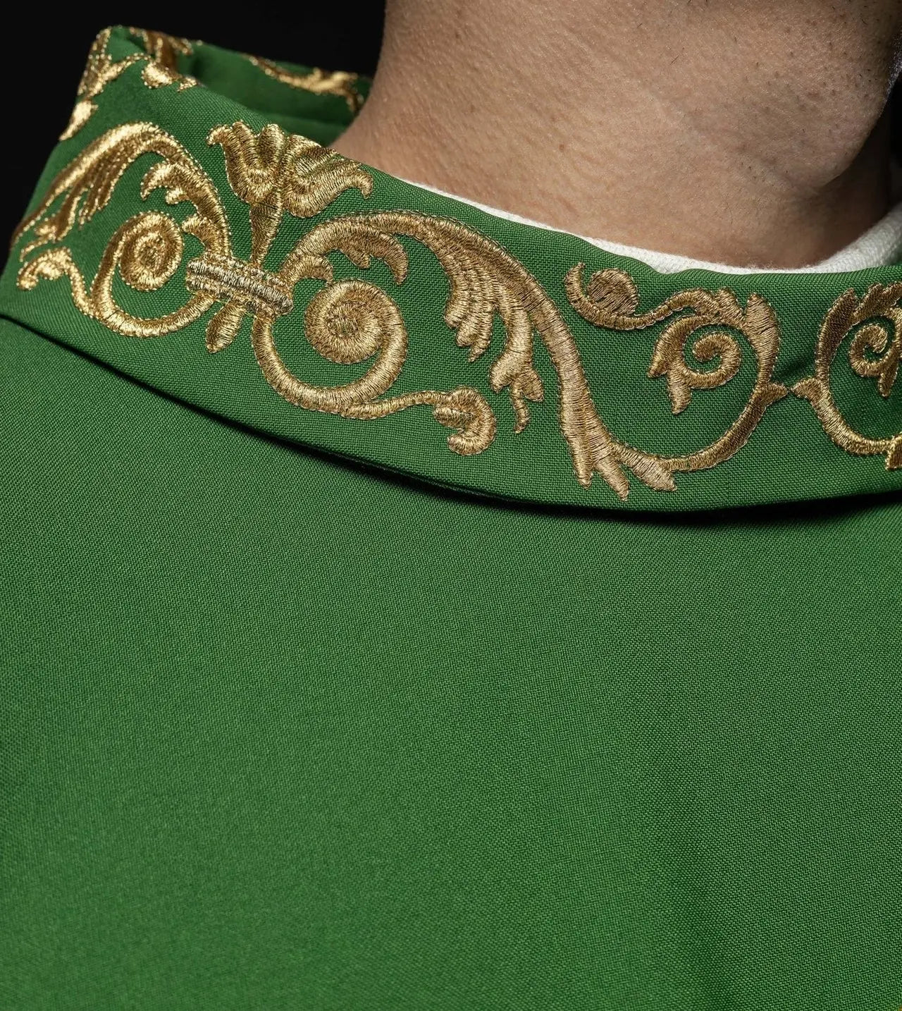Green chasuble with gold IHS embroidery and decorative trim