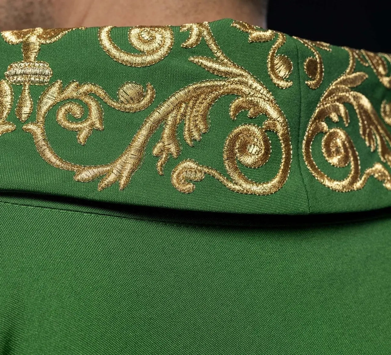 Green chasuble with gold IHS embroidery and decorative trim