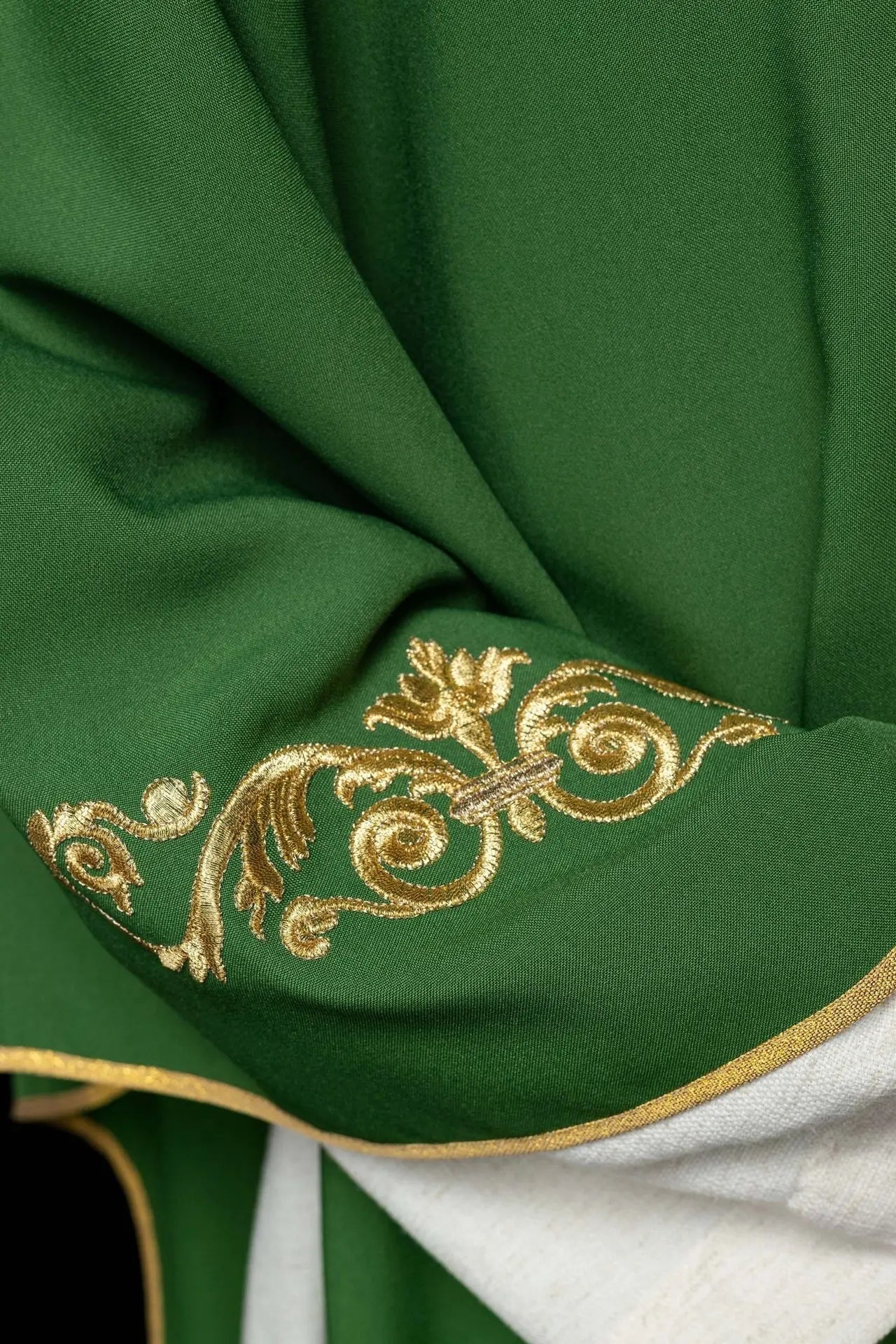 Green chasuble with gold IHS embroidery and decorative trim