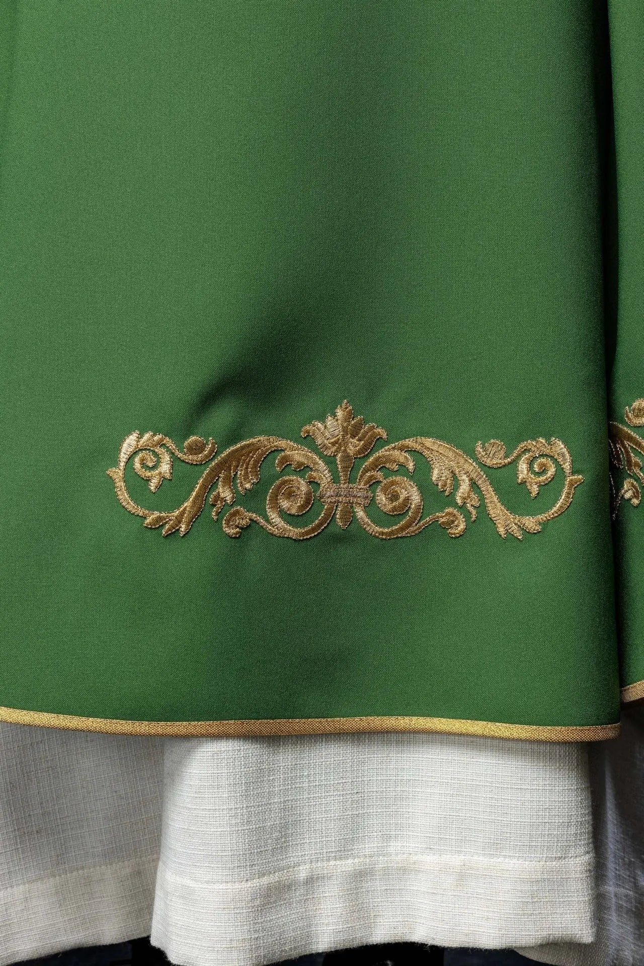 Green chasuble with gold IHS embroidery and decorative trim