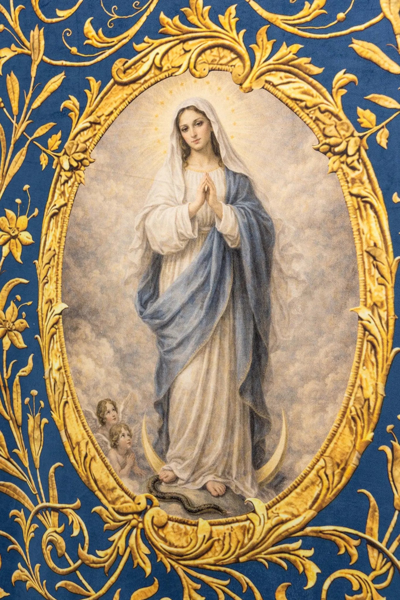 Double-sided blue processional banner with an image of Our Lady of the Immaculate Conception on one side and a Marian monogram on the other, both surrounded by gold floral ornamentation and finished with gold fringes.