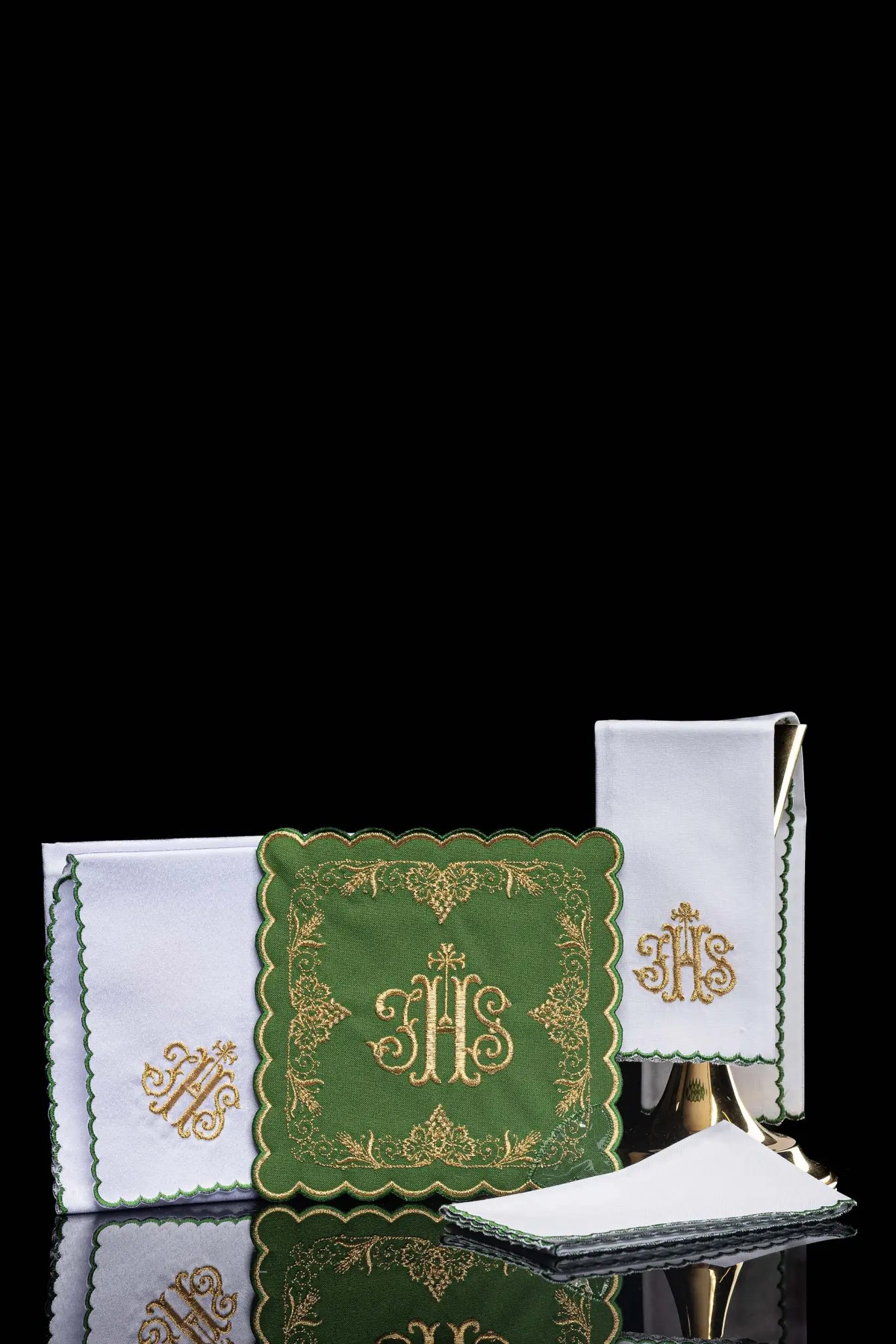 Green chalice linen set with IHS monogram, cross, acanthus leaves, and grapevines embroidered in gold. Includes pall, corporal, purificator, and lavabo towel.