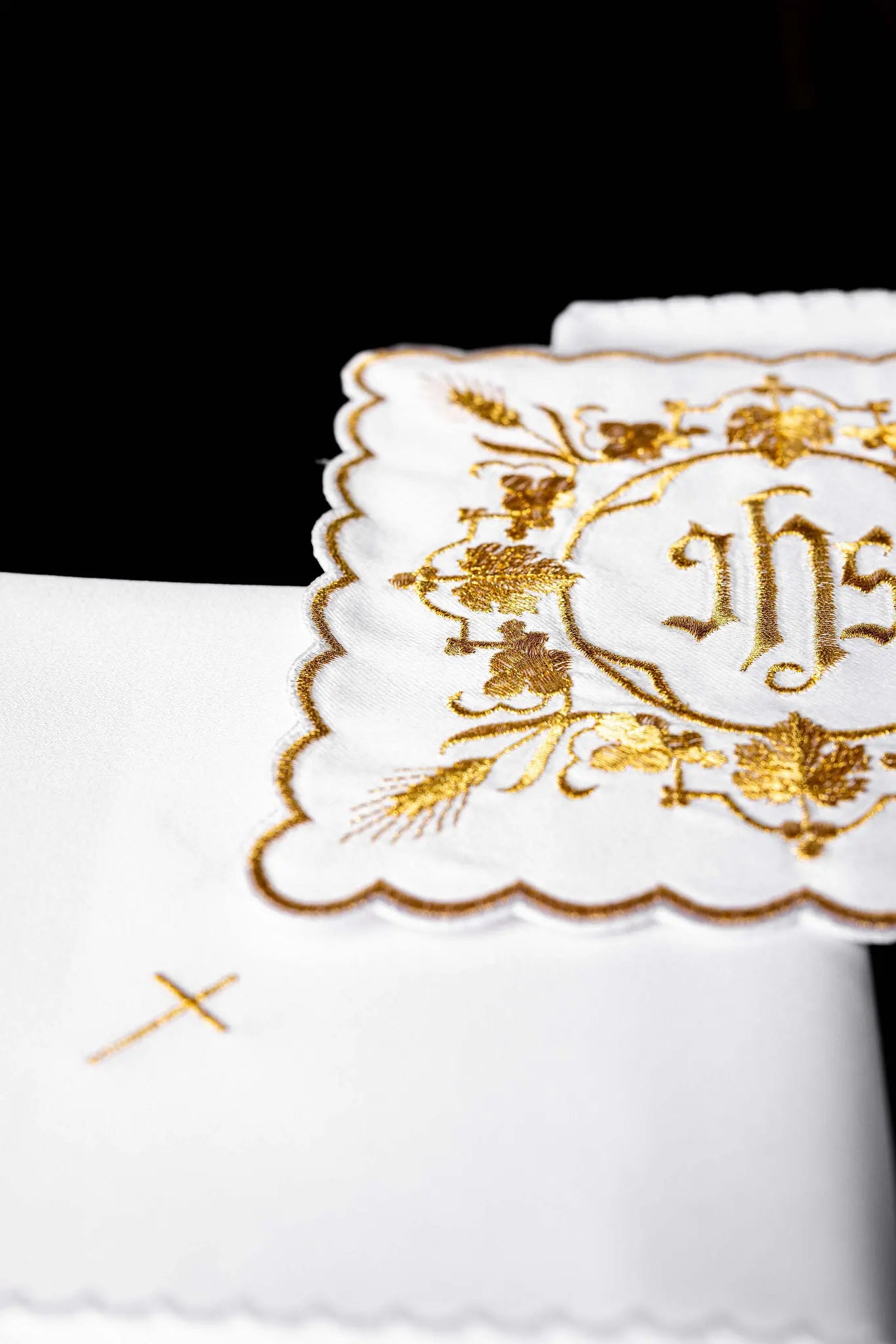 White chalice linen set with IHS embroidery on pall, purificator, and lavabo towel.