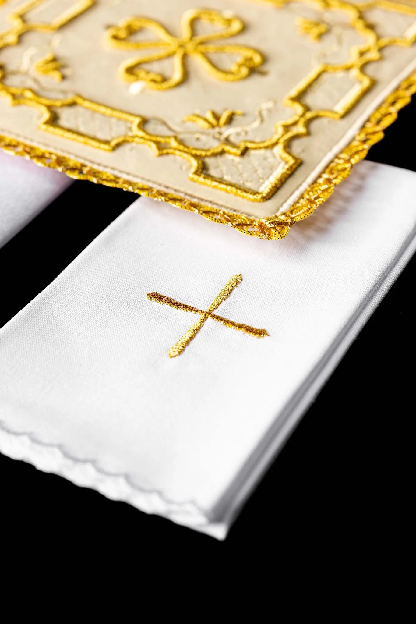 Ecru chalice linen set with velvet pall, corporal, purificator, and lavabo towel. The velvet pall features a central gold embroidered rosette cross with floral and geometric patterns and gold lace trim. The purificator and lavabo towel have a small gold embroidered cross and scalloped edges.