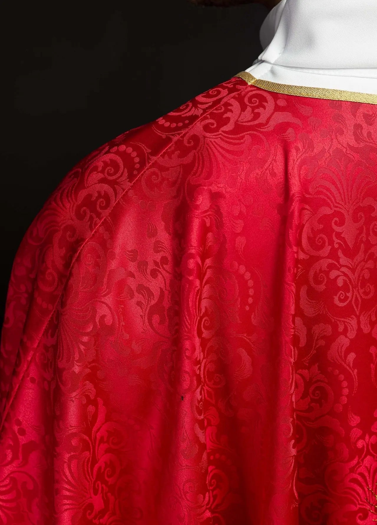 Red liturgical chasuble with an embroidered chalice and host on jacquard fabric