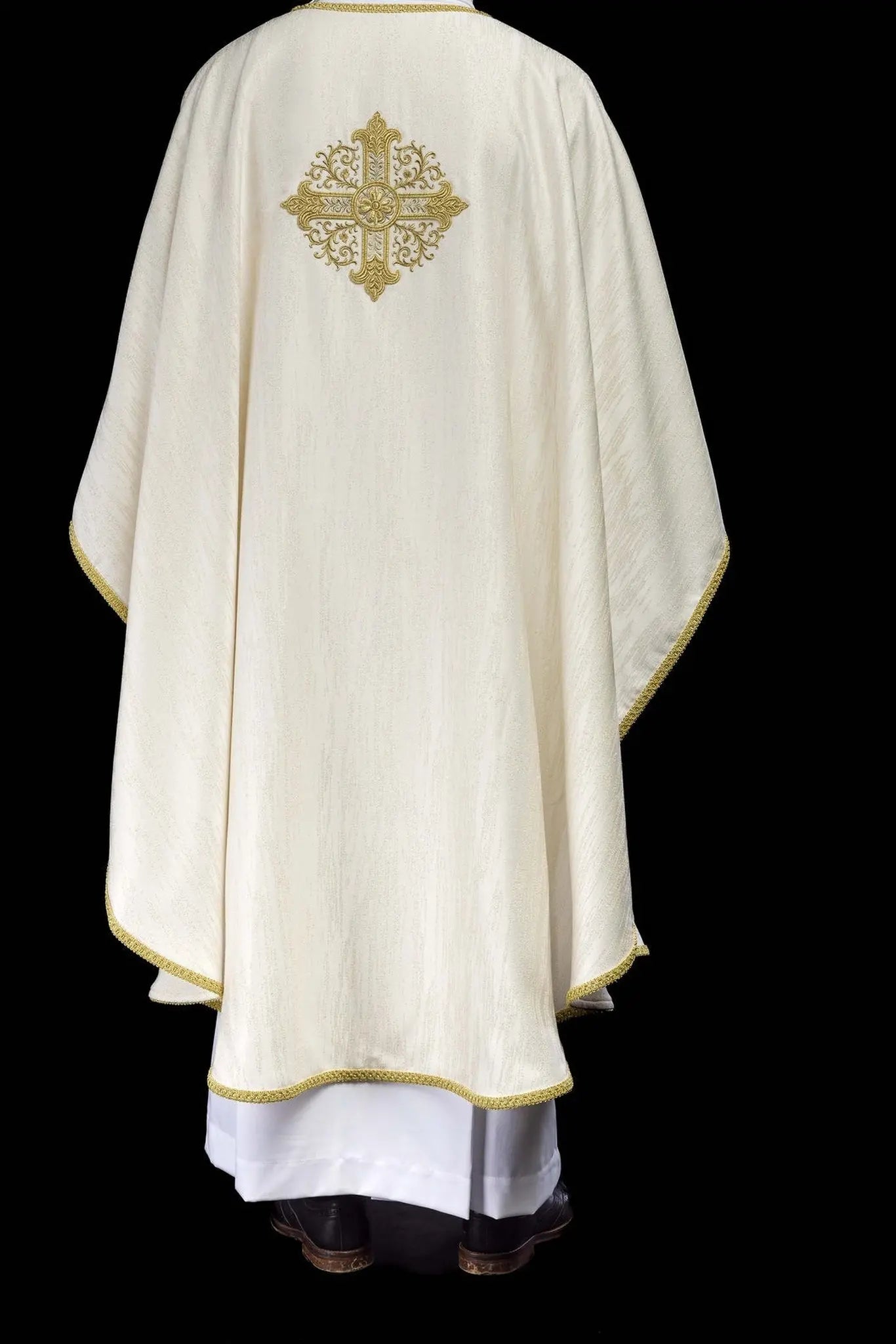 Ecru chasuble with embroidered cross motif on decorative fabric