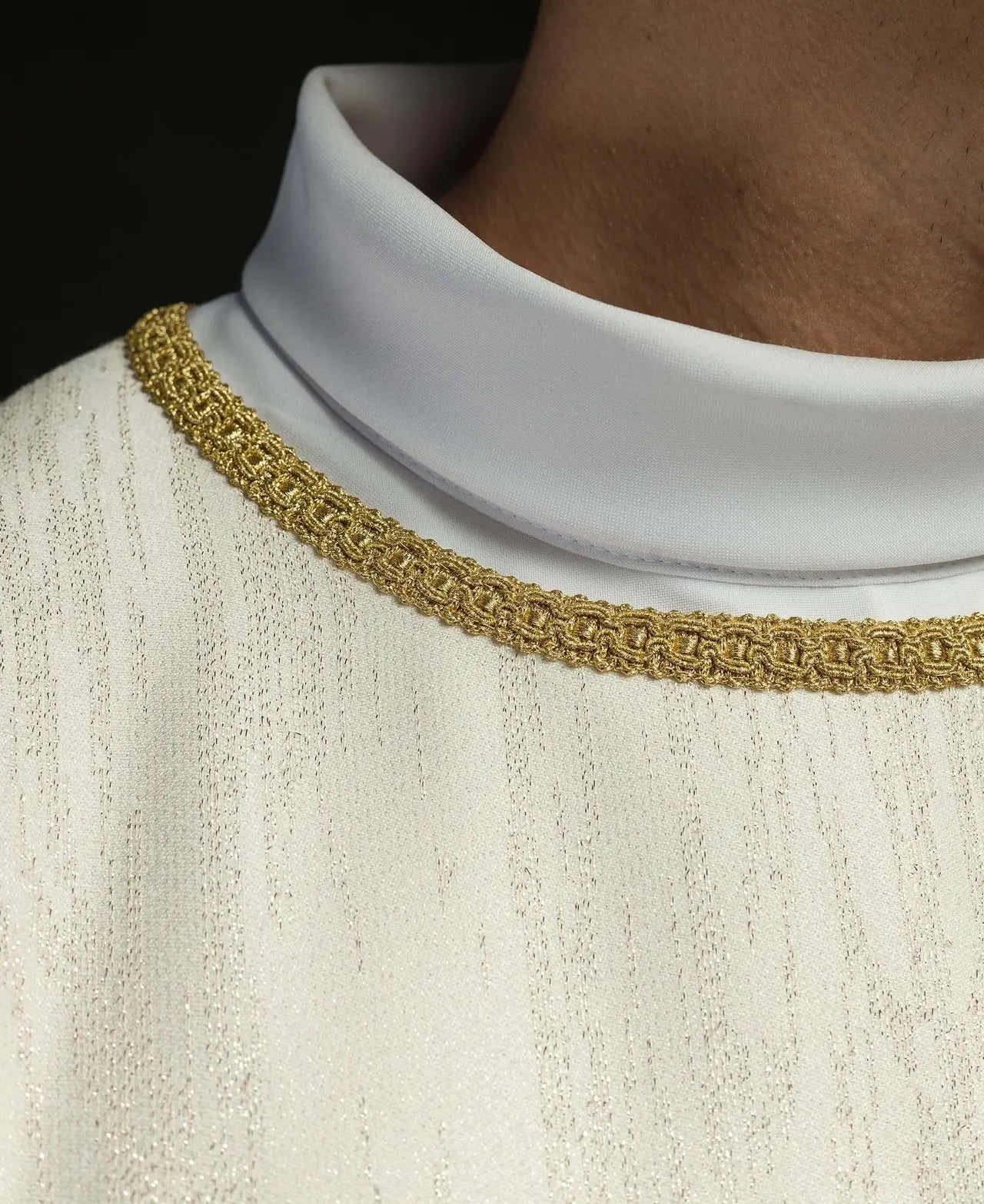 Ecru chasuble with embroidered cross motif on decorative fabric