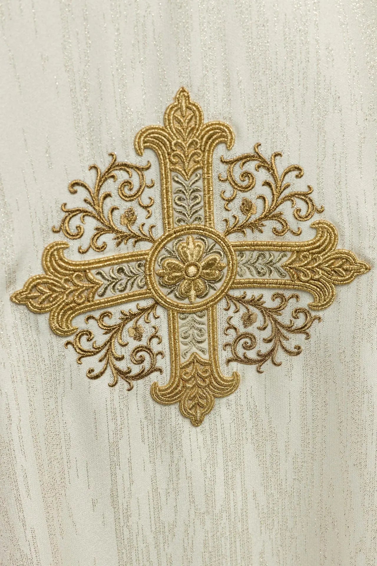 Ecru chasuble with embroidered cross motif on decorative fabric