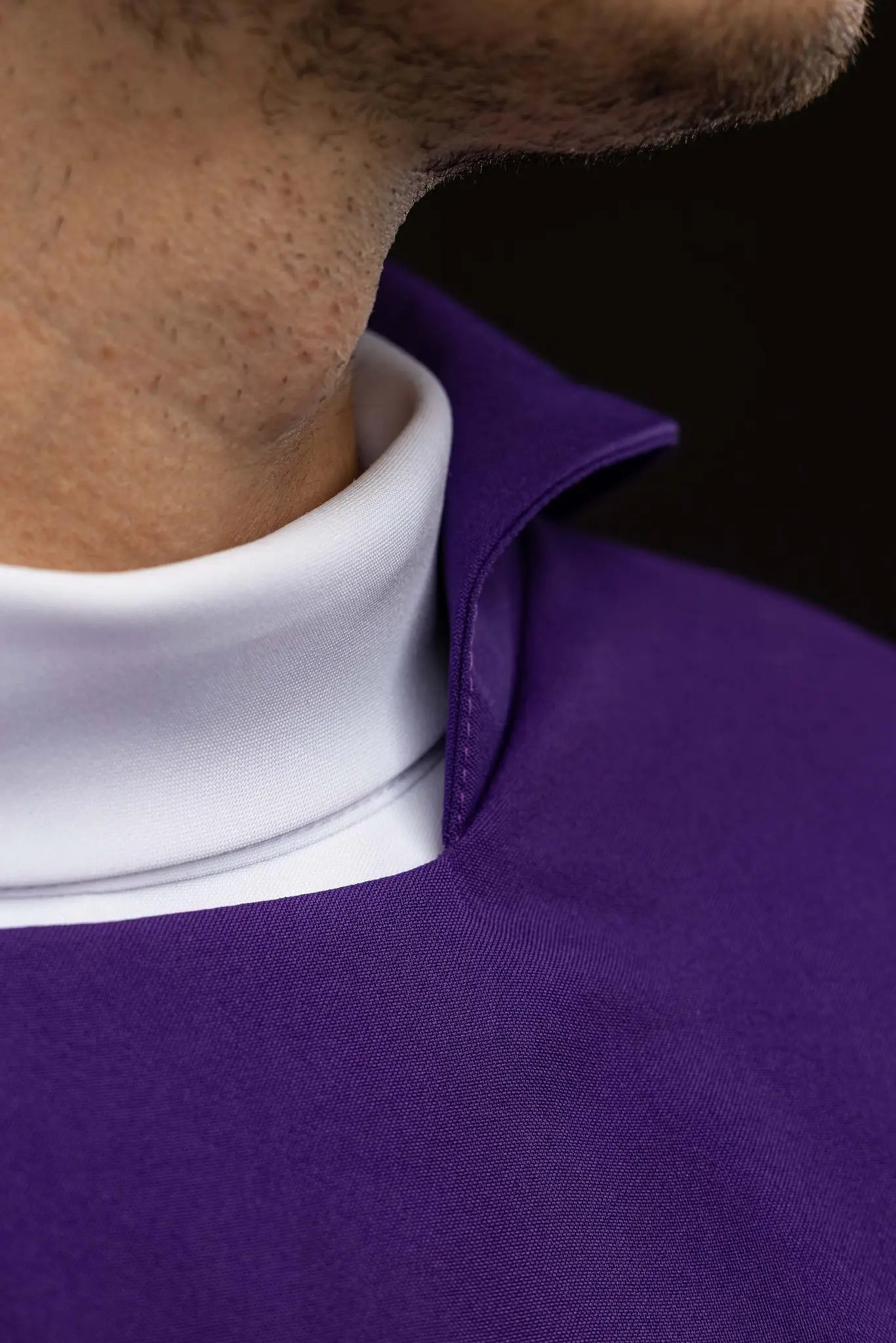 Purple chasuble with embroidered IHS symbol and gold trim, featuring a V-neckline and a matching stole.