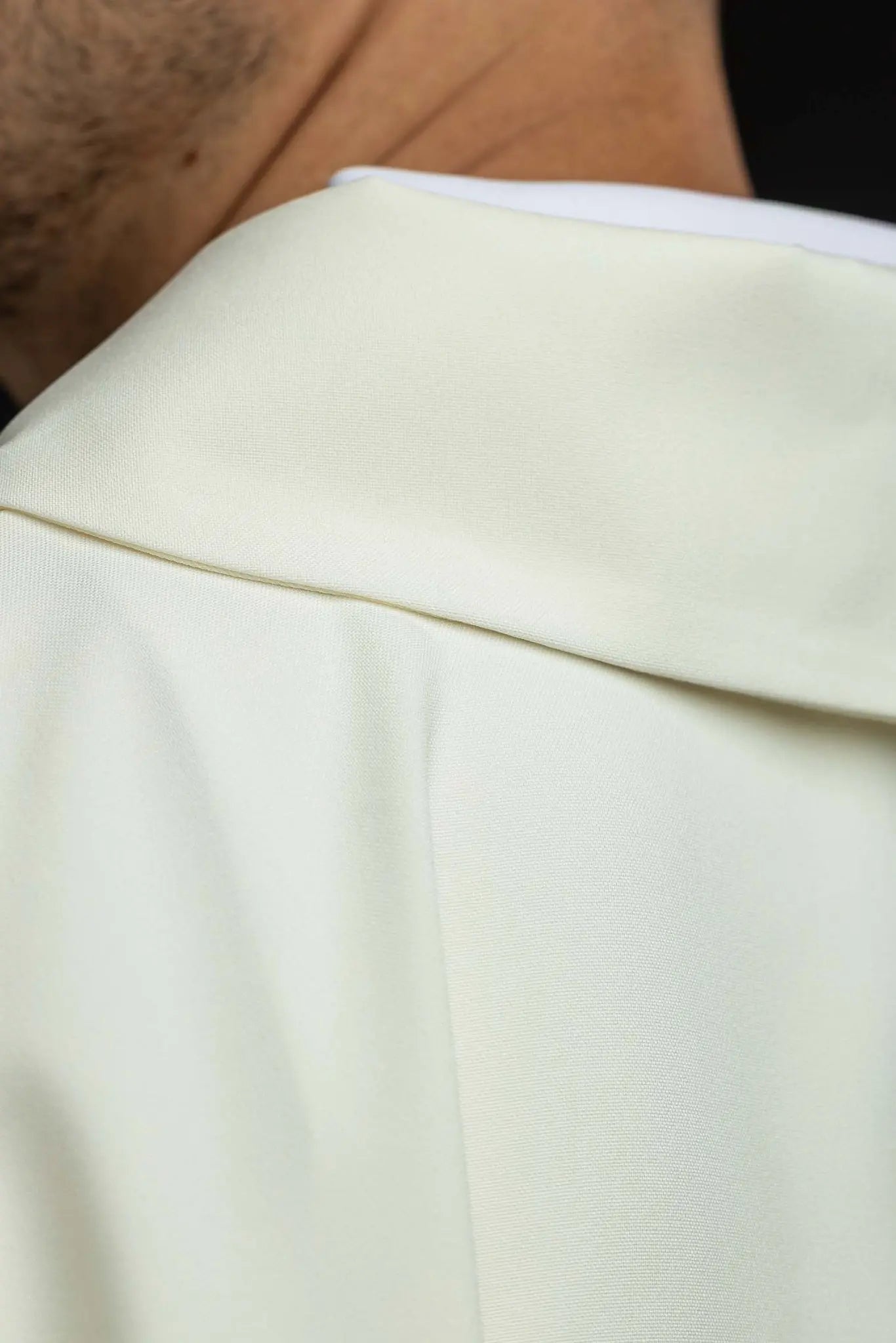 Ecru chasuble with gold IHS embroidery and gold trim, featuring a V-neck collar.