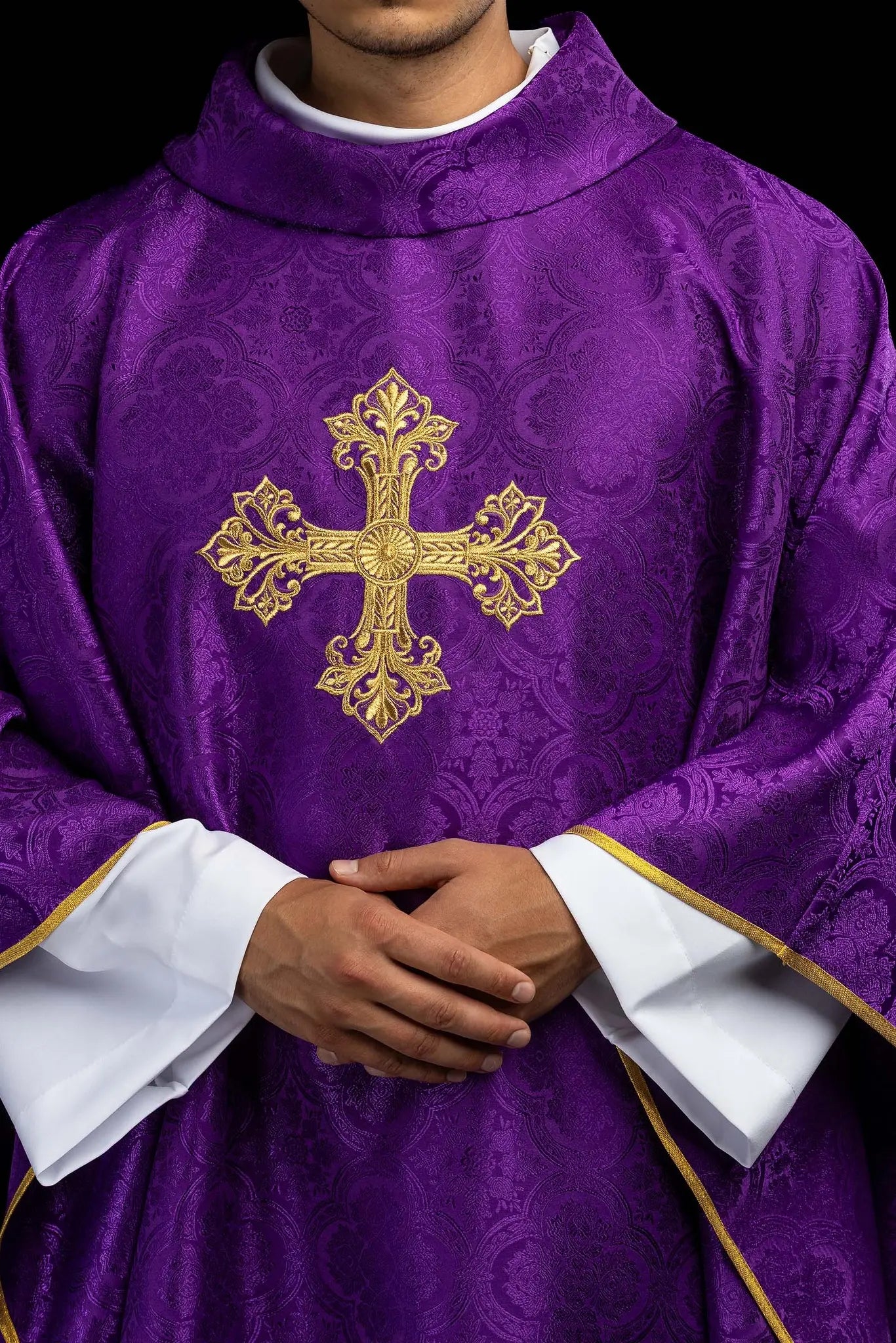 Purple chasuble with a gold embroidered cross on jacquard fabric, featuring a stand-up collar and gold trim.