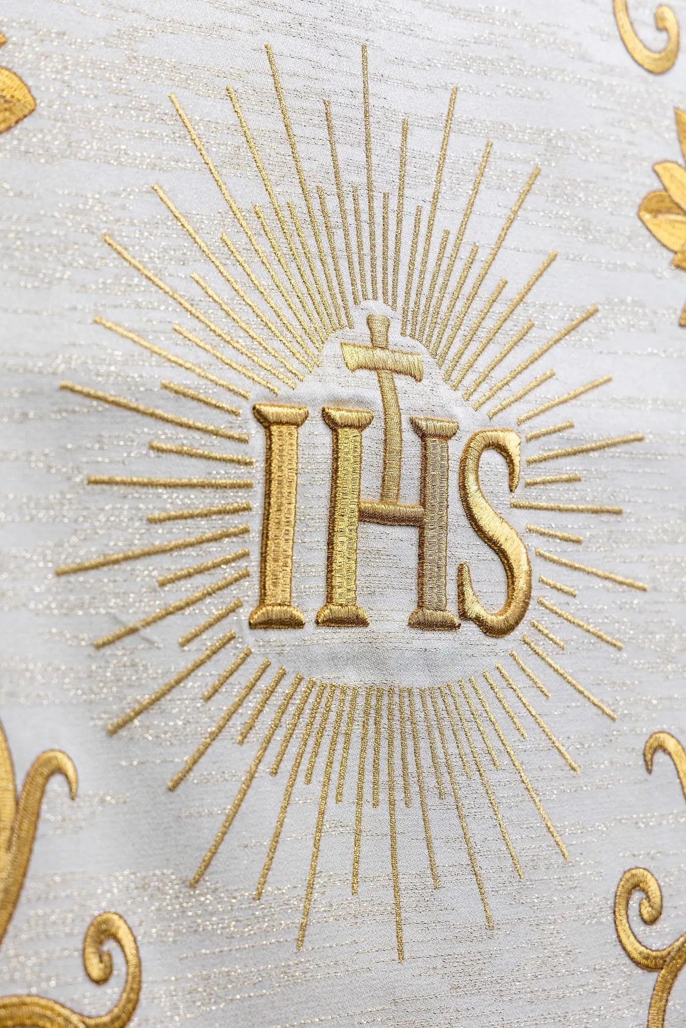 Ecru lectern cover with rich gold IHS monogram embroidery, radiant glory, wheat sheaves, and grapevines, finished with gold fringes.