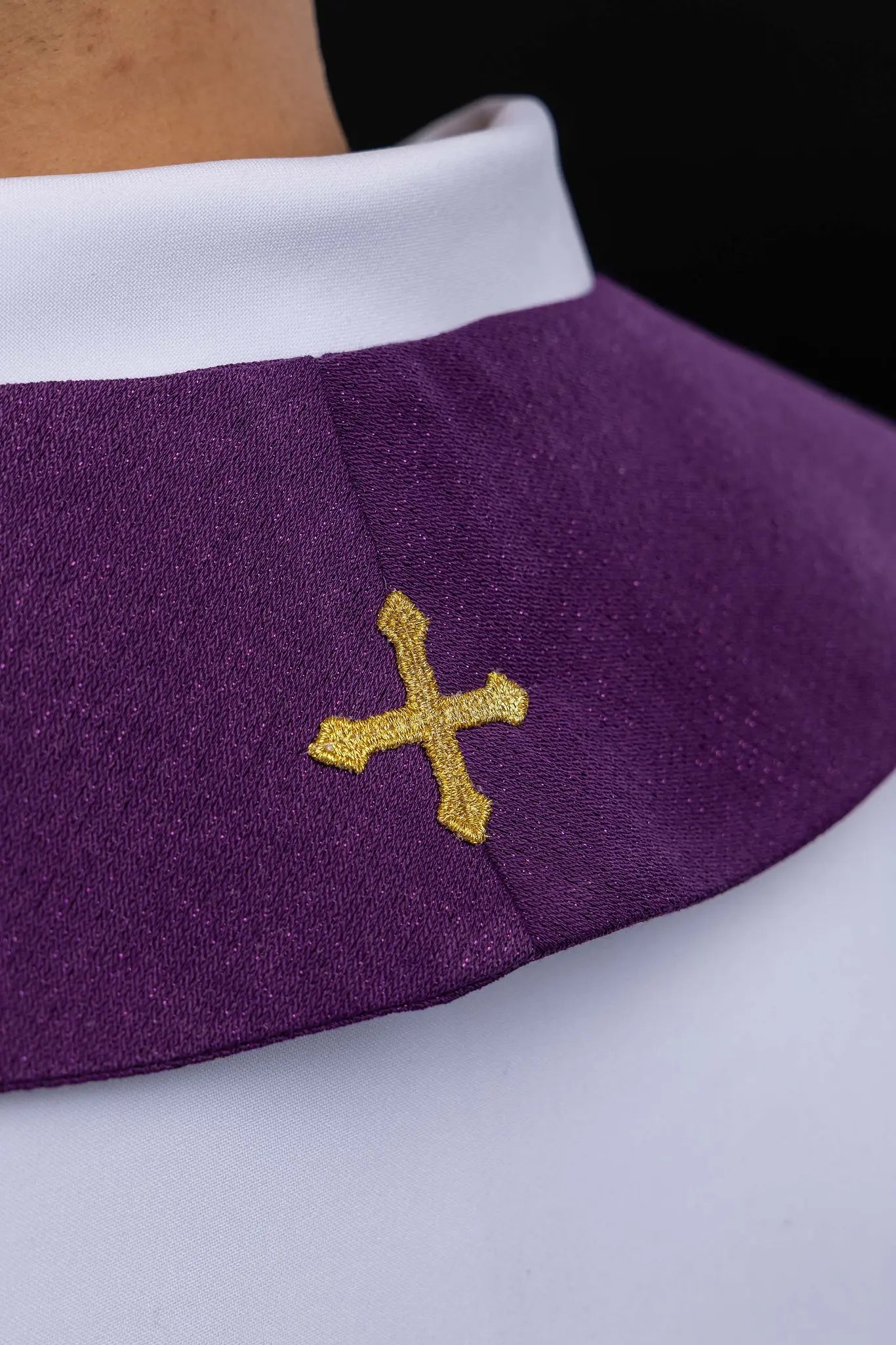 Purple Advent stole with gold IHS embroidery and Advent candle motif, made from shimmering fabric.