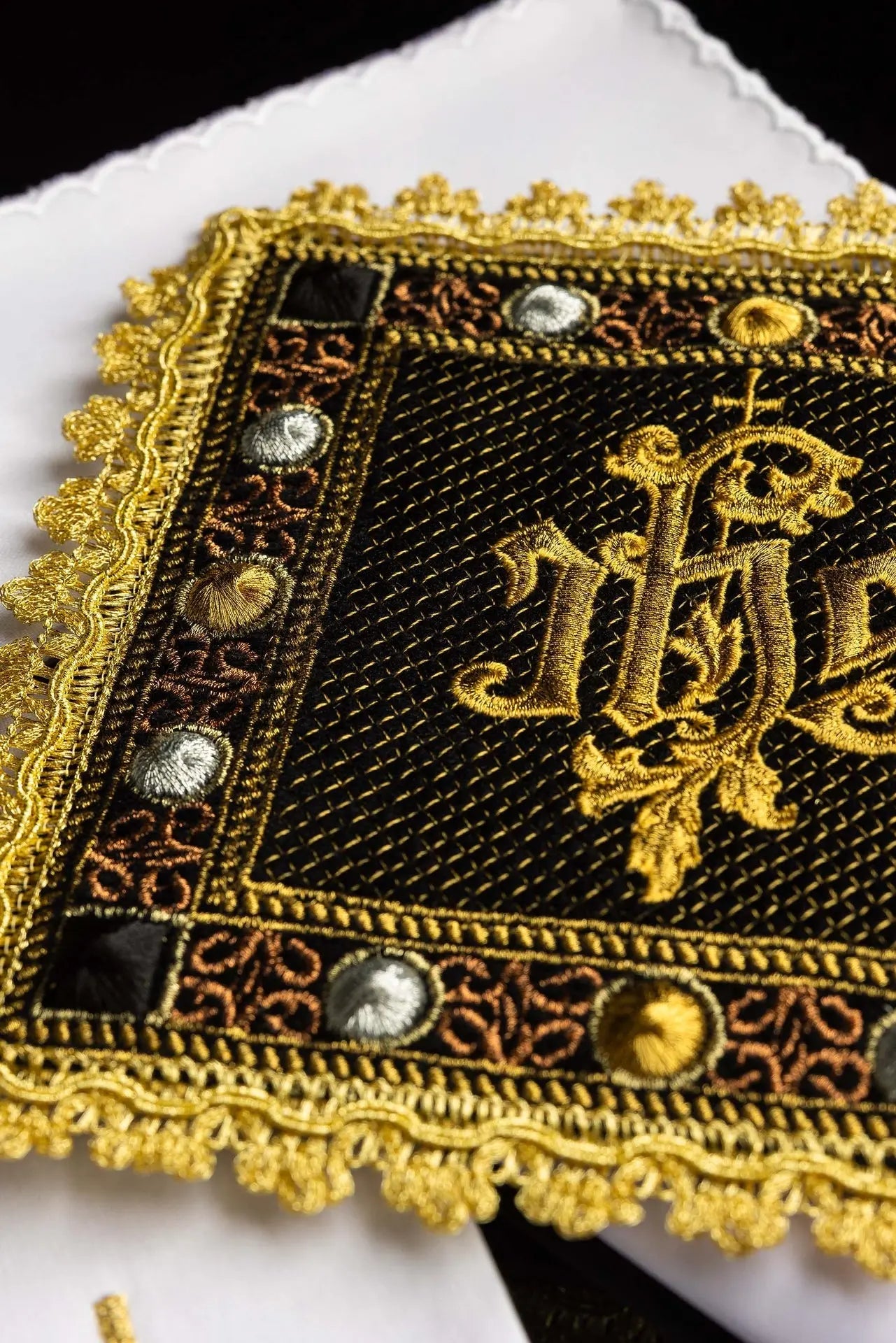 A black velvet chalice linens set with an embroidered IHS symbol