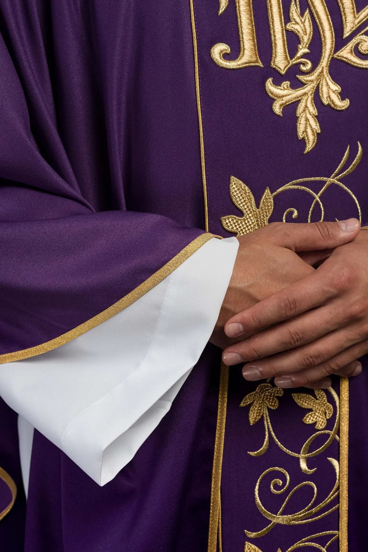 Purple liturgical chasuble with richly decorated belt with floral motif and IHS