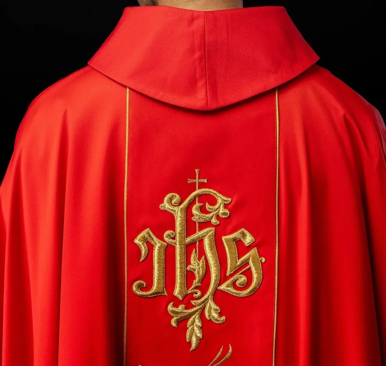 Czerwony ornat liturgiczny z bogato zdobionym pasem z motywem kwiatowym i IHS